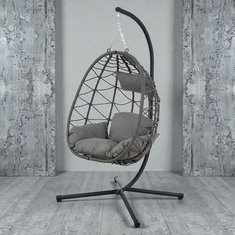 Coocosh egg-shaped hanging chair with gray PE netting and plush cushions, featuring a sturdy black metal stand for ultimate relaxation and comfort in a modern indoor setting.
