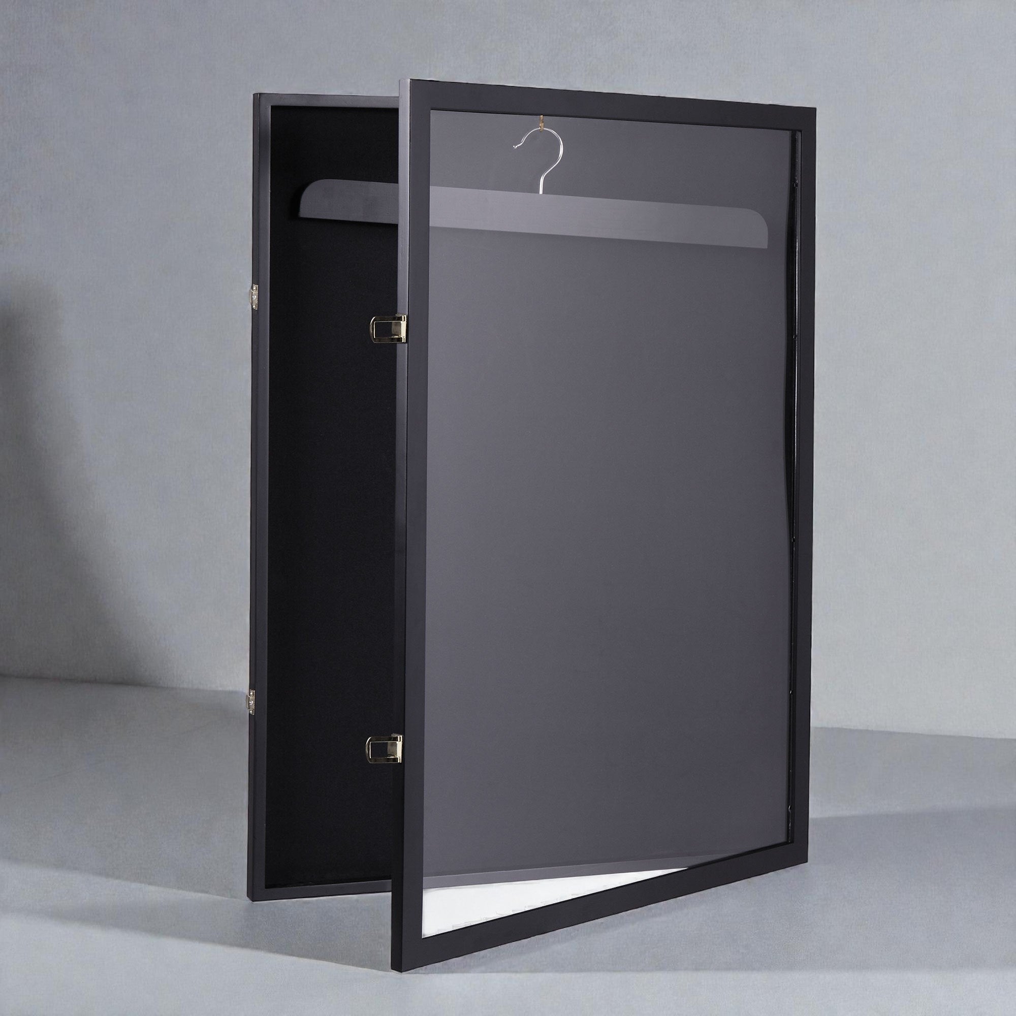 Coocosh black wardrobe with a frosted glass door, featuring a hanging rod and brass hardware, shown from a side angle to showcase its modern design and functionality.
