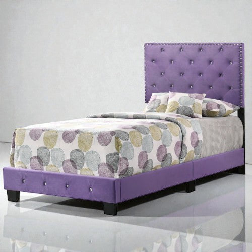 Coocosh twin size bed with a purple tufted headboard and crystal accents, upholstered in purple fabric with a patterned comforter, showcased from a front-facing perspective.
