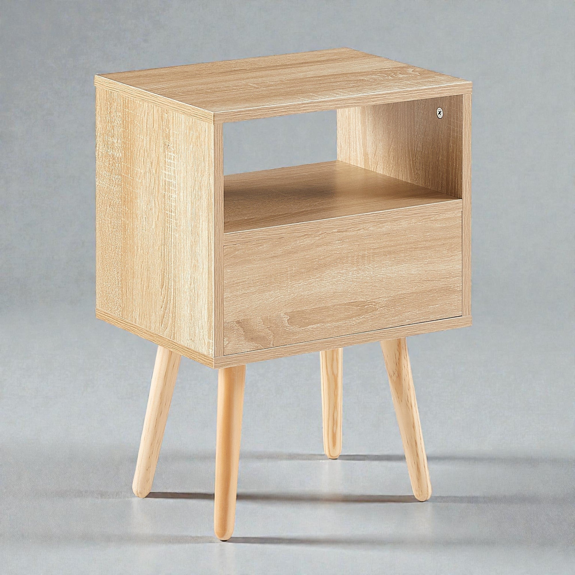 Coocosh nightstand with shelf and drawer. Crafted with light oak wood, providing both concealed storage and display space, elevated by three legs. Functional and stylish.