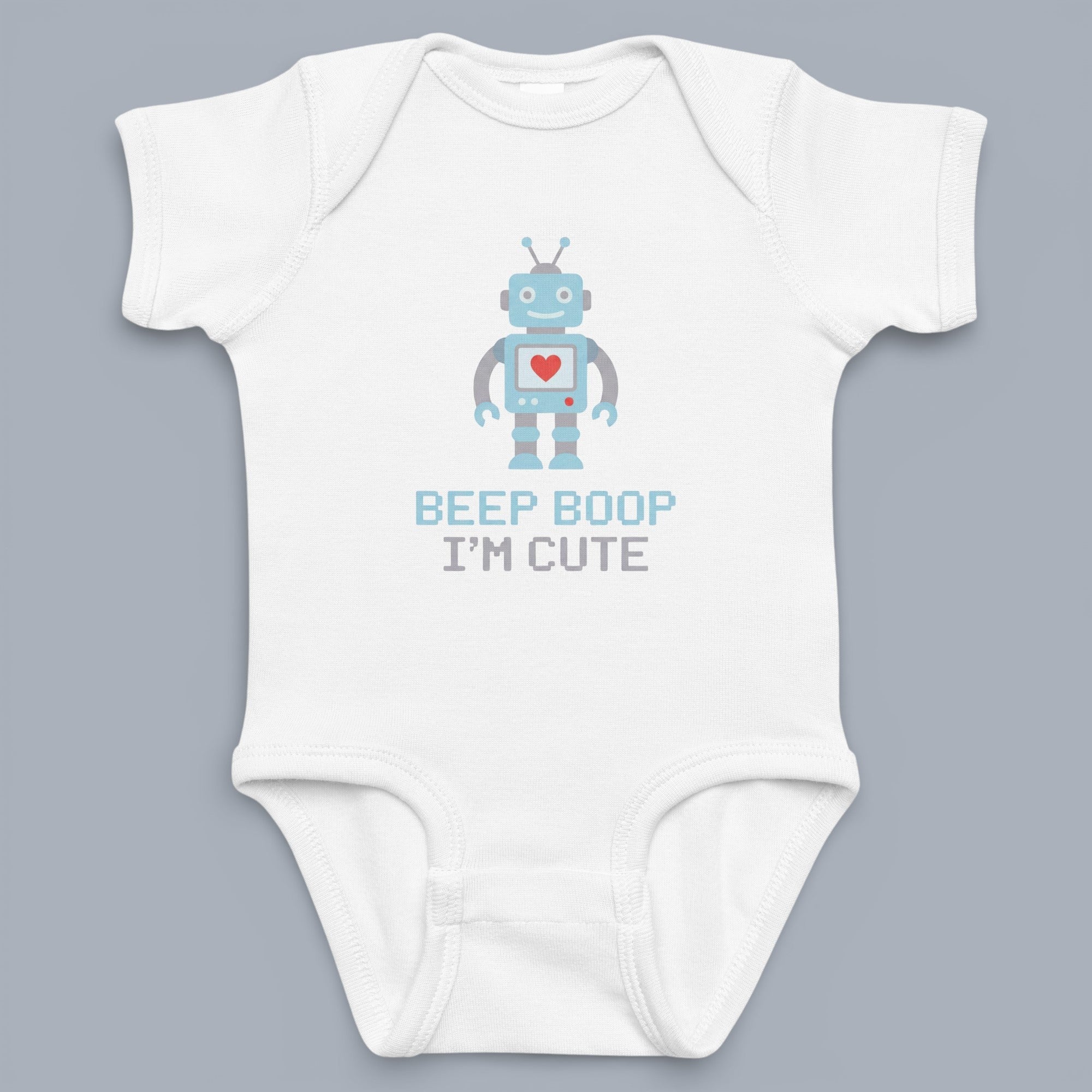 Coocosh Baby Bodysuit, featuring a cute robot graphic with a heart on the chest and the text 'Beep Boop I'm Cute', white color, shown on a gray background. A fun and playful piece for babies.