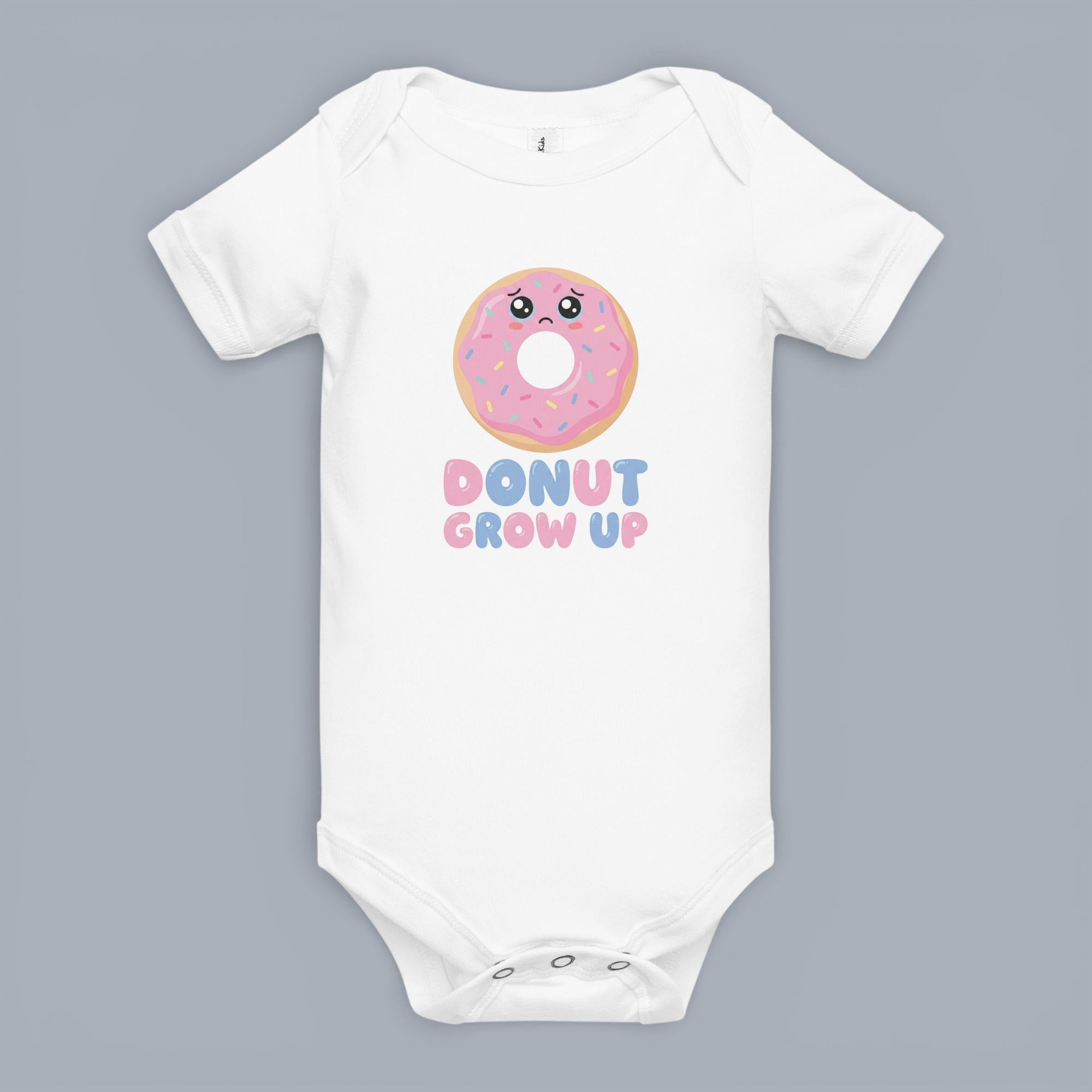 Coocosh Baby Bodysuit featuring a cute sad donut graphic with the phrase "Donut Grow Up", short sleeves, and a comfortable fit for infants. White onesie on a neutral backdrop. Period.