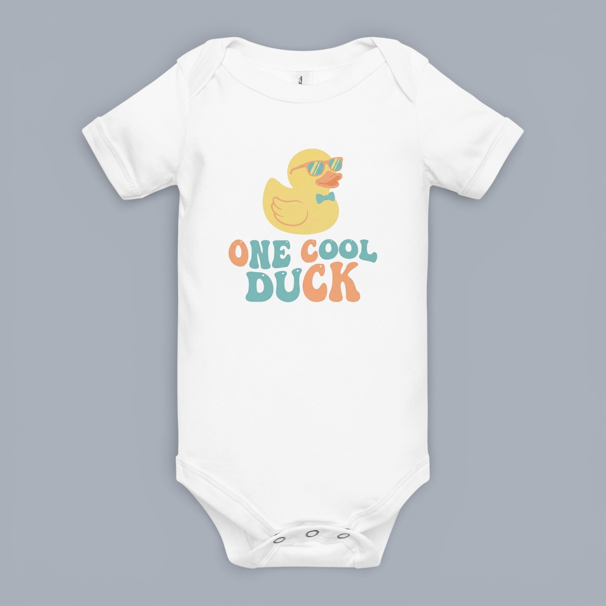 Coocosh baby bodysuit featuring a cool duck graphic. The design showcases a cartoon duck with sunglasses and a bow tie, accompanied by the text 'ONE COOL DUCK'. Soft and comfortable for everyday wear. A fun and playful piece for infants. Front view.