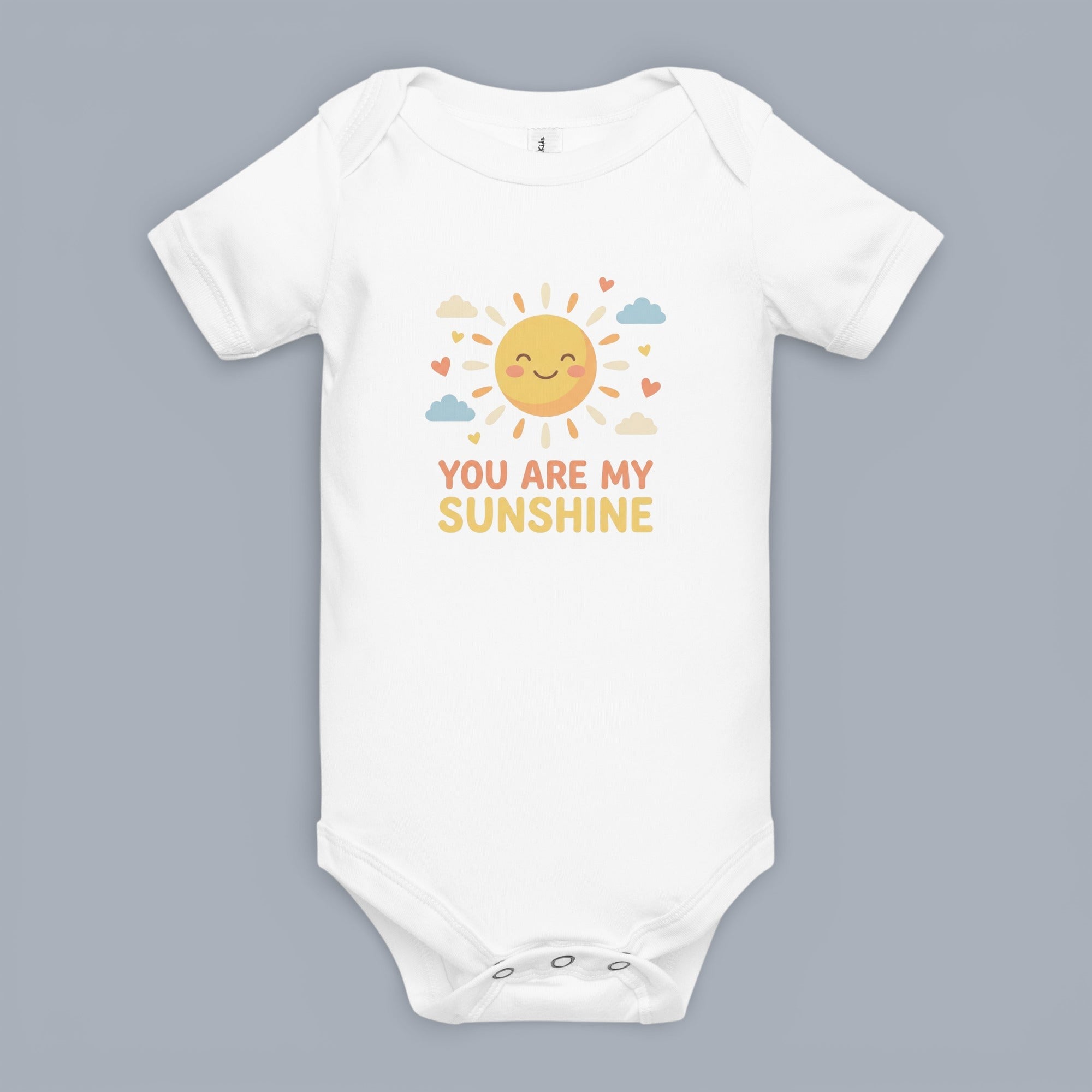 Coocosh Baby Onesie featuring a smiling sun graphic surrounded by hearts and clouds, with the text 'You are my sunshine' on a white cotton blend onesie. Standard fit.