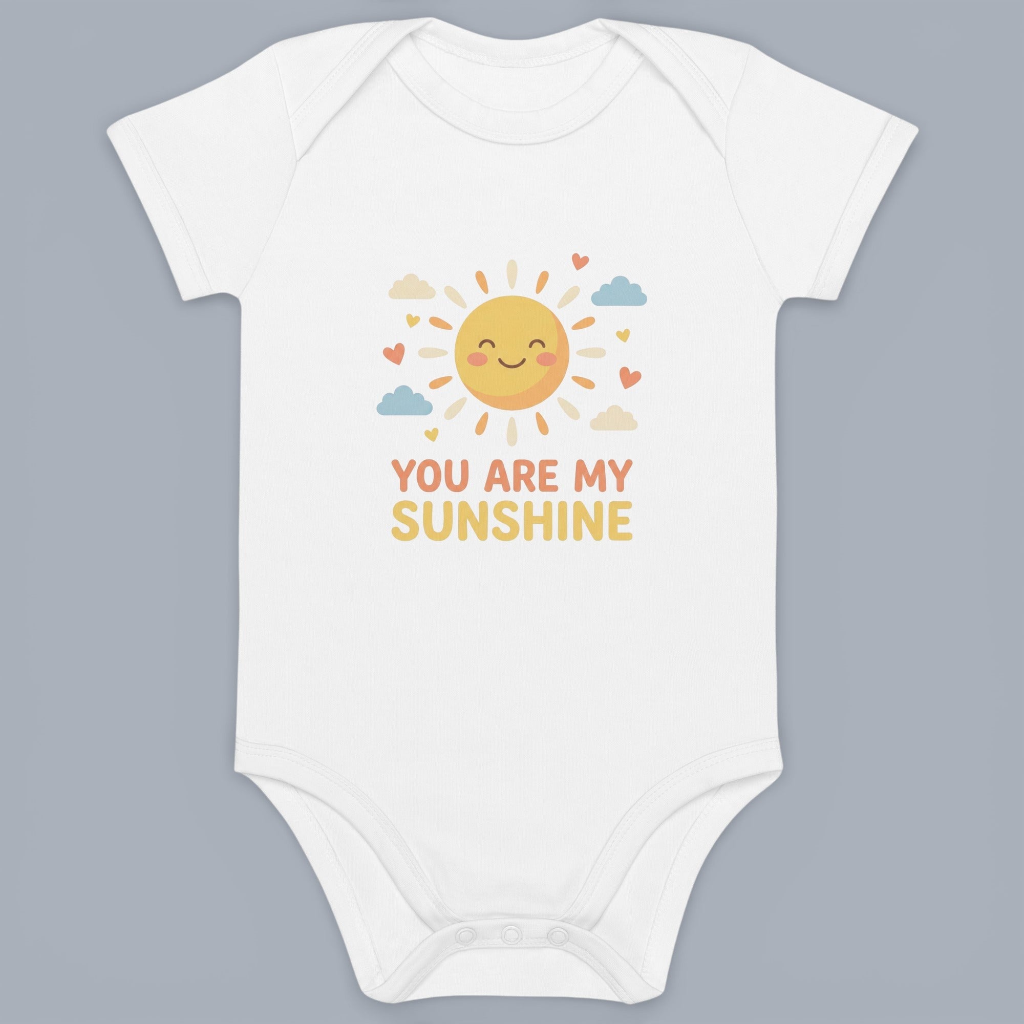 Coocosh Baby Bodysuit features a delightful cartoon sun graphic with heart and cloud accents, made from soft white cotton. Perfect for adding sunshine to your little one's wardrobe. The playful design and comfortable fabric make it an ideal gift, shown in