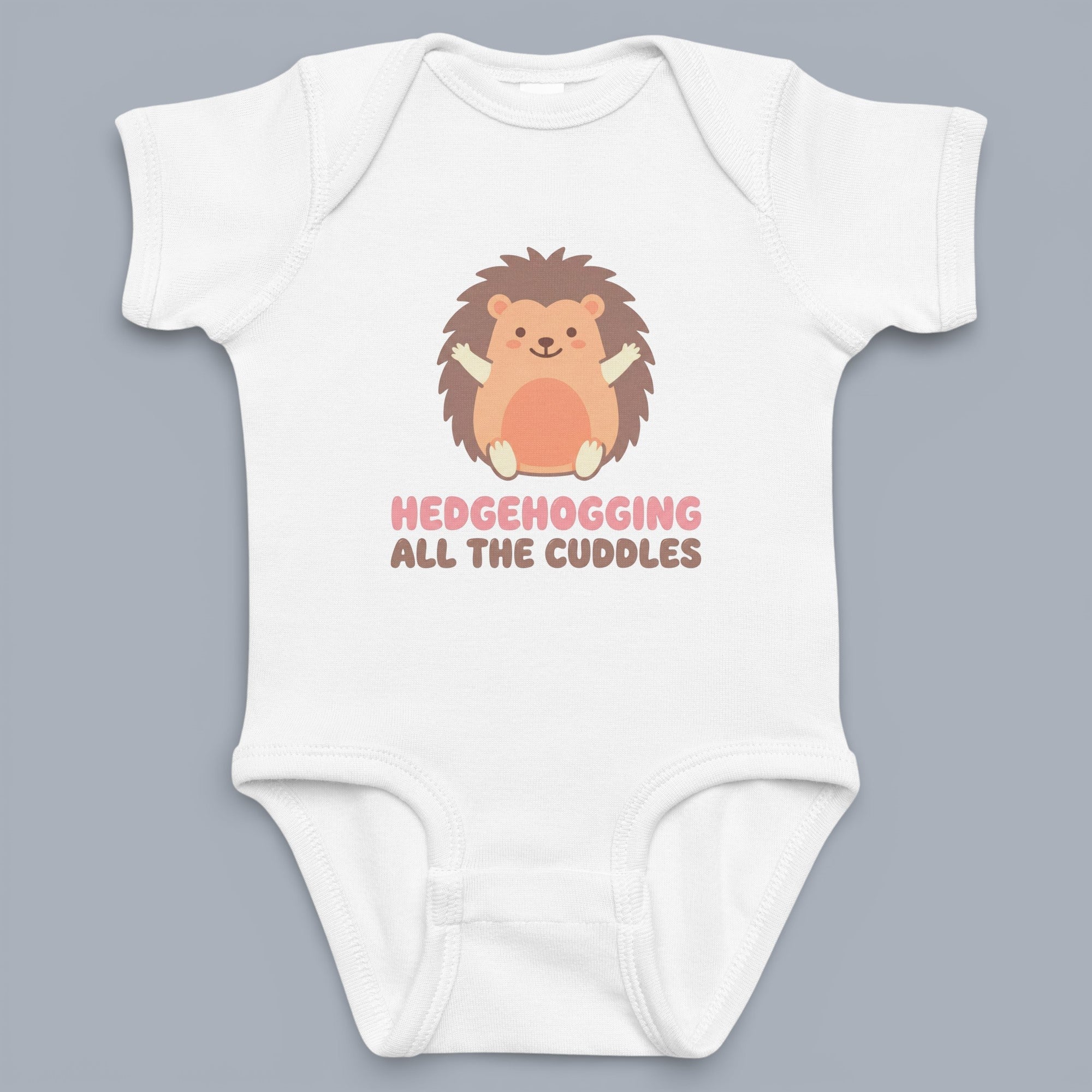 Coocosh baby onesie with a cute hedgehog graphic, ideal for infant wear. Features soft, breathable cotton, short sleeves, and a charming design. White color for easy care. Perfect for cuddling all day long. The perspective is flat lay. Period.