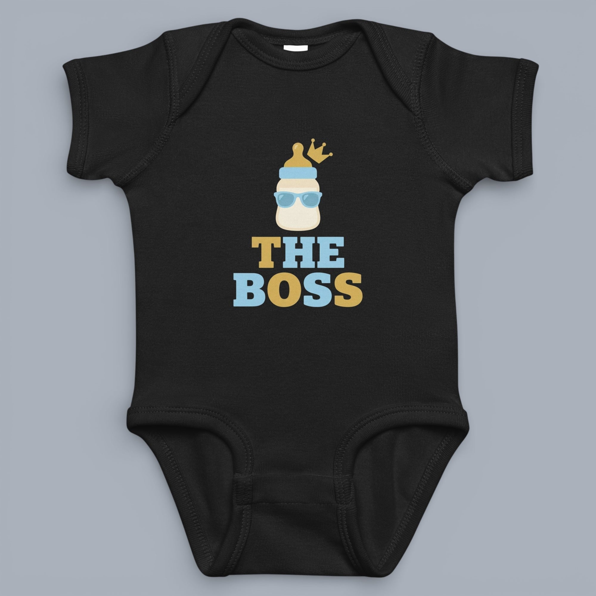 Coocosh baby bodysuit featuring a milk bottle with sunglasses and a crown. The text "THE BOSS" is printed underneath the bottle design. The bodysuit is black and is displayed on a neutral background.