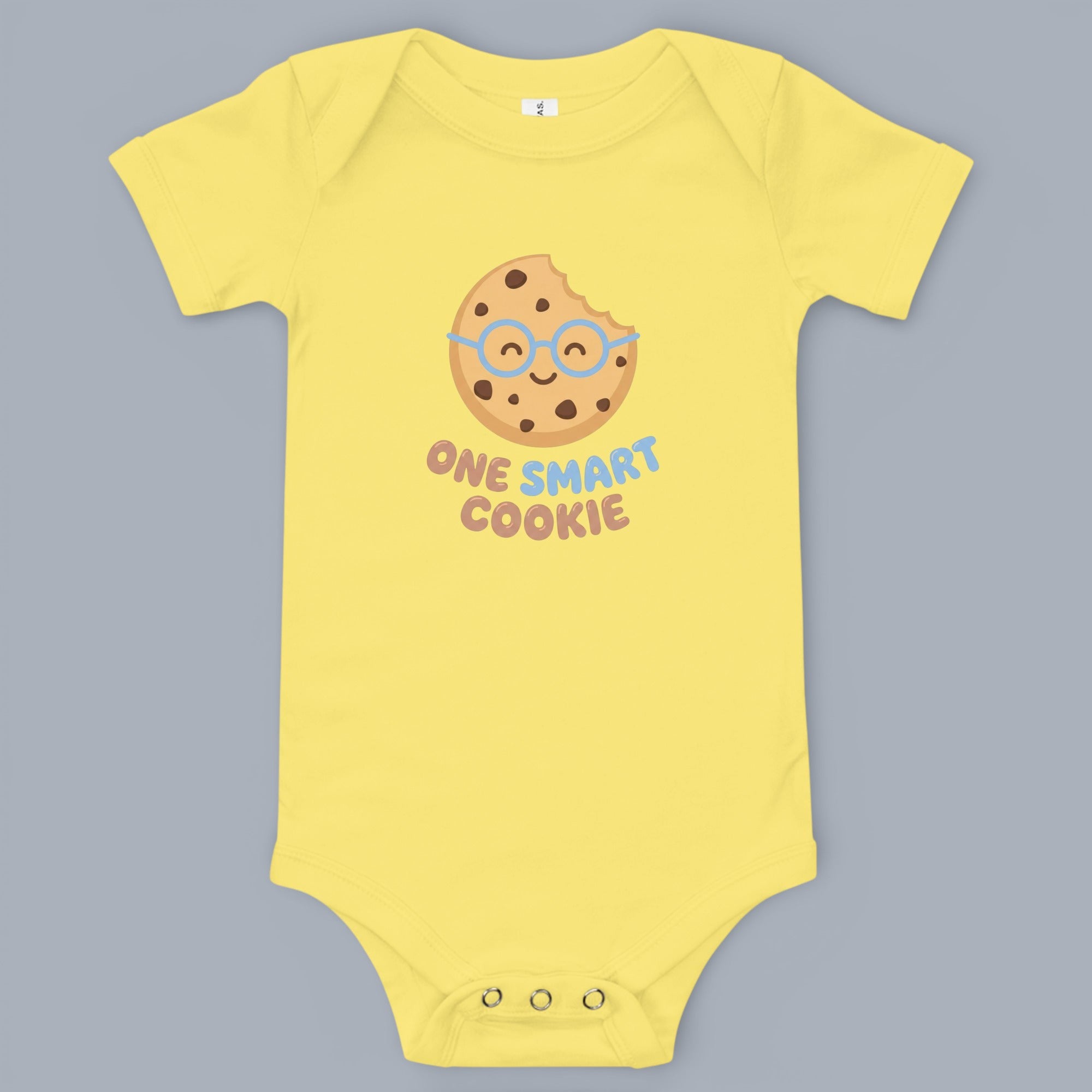 Coocosh Baby Onesie featuring a funny cookie graphic that says "One Smart Cookie", made of soft and breathable cotton, in yellow color, displayed in a studio setting. Perfect for baby photoshoots and gifts.