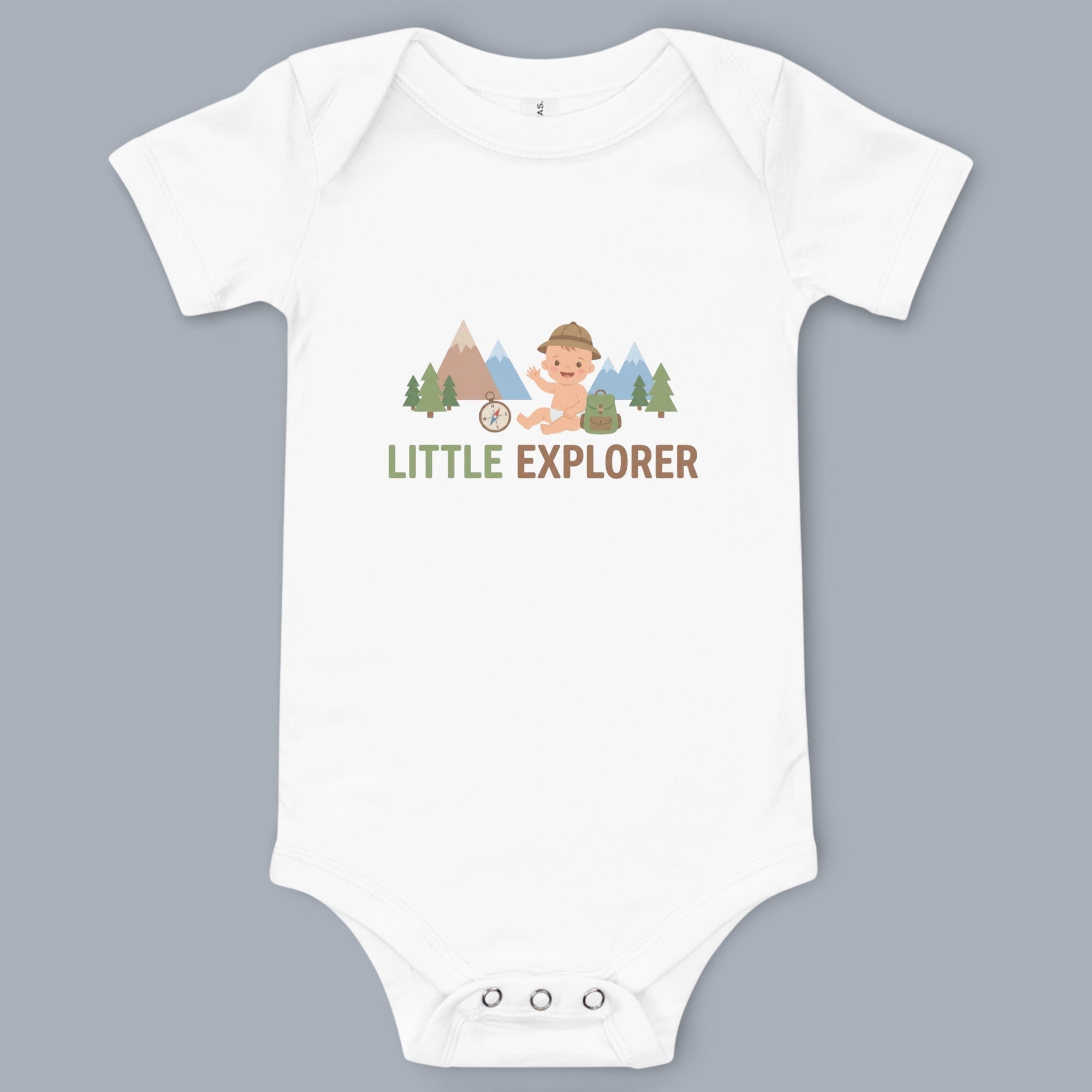 Coocosh Baby Bodysuit featuring a whimsical "Little Explorer" design with a cartoon baby, mountains, trees, compass, and backpack. The bodysuit is white, short-sleeved. A fun and adventurous design perfect for your little one's wardrobe.