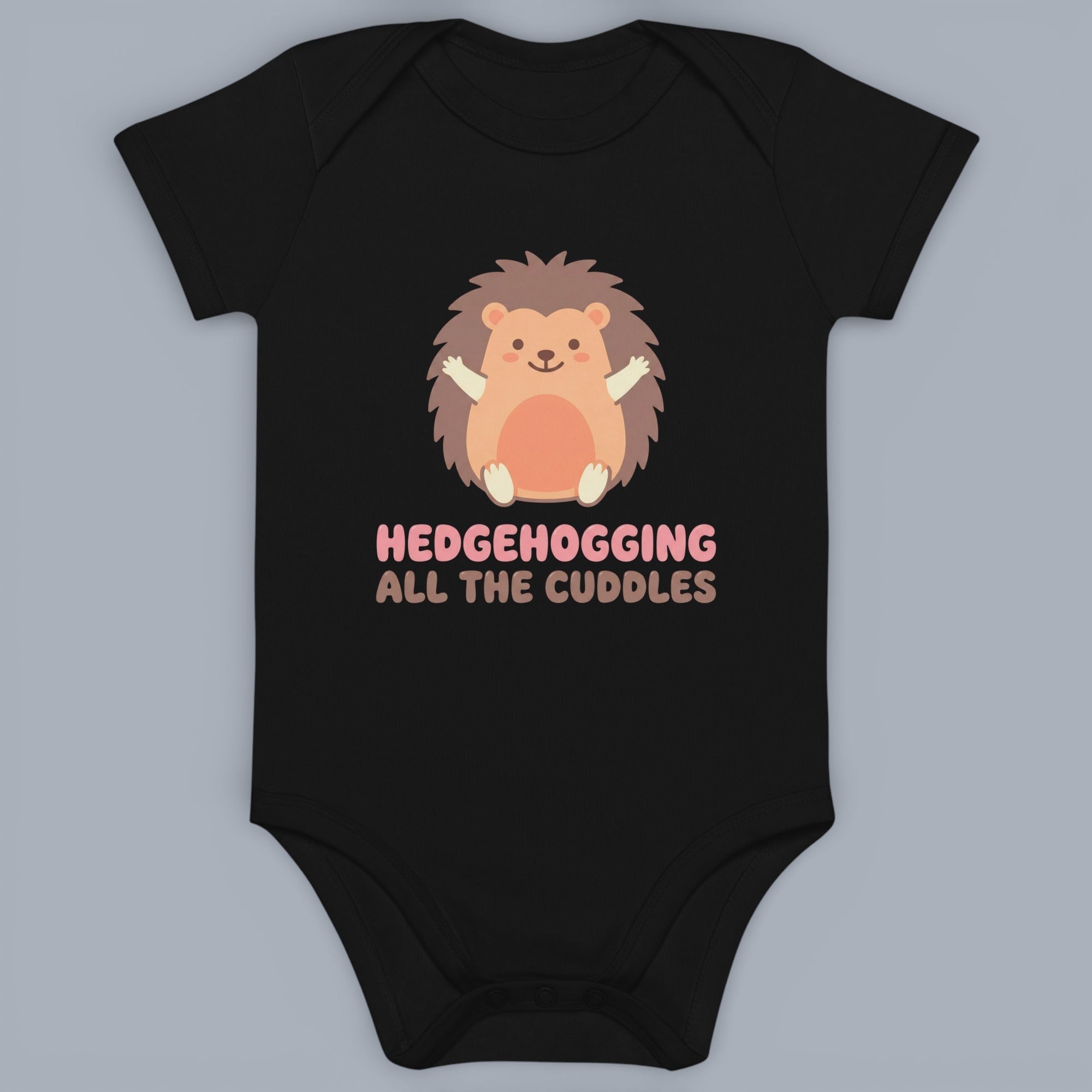Coocosh baby bodysuit featuring a cute hedgehog graphic with the text "Hedgehogging All the Cuddles." This onesie is made of soft, comfortable fabric and is black in color. Perfect for baby.
