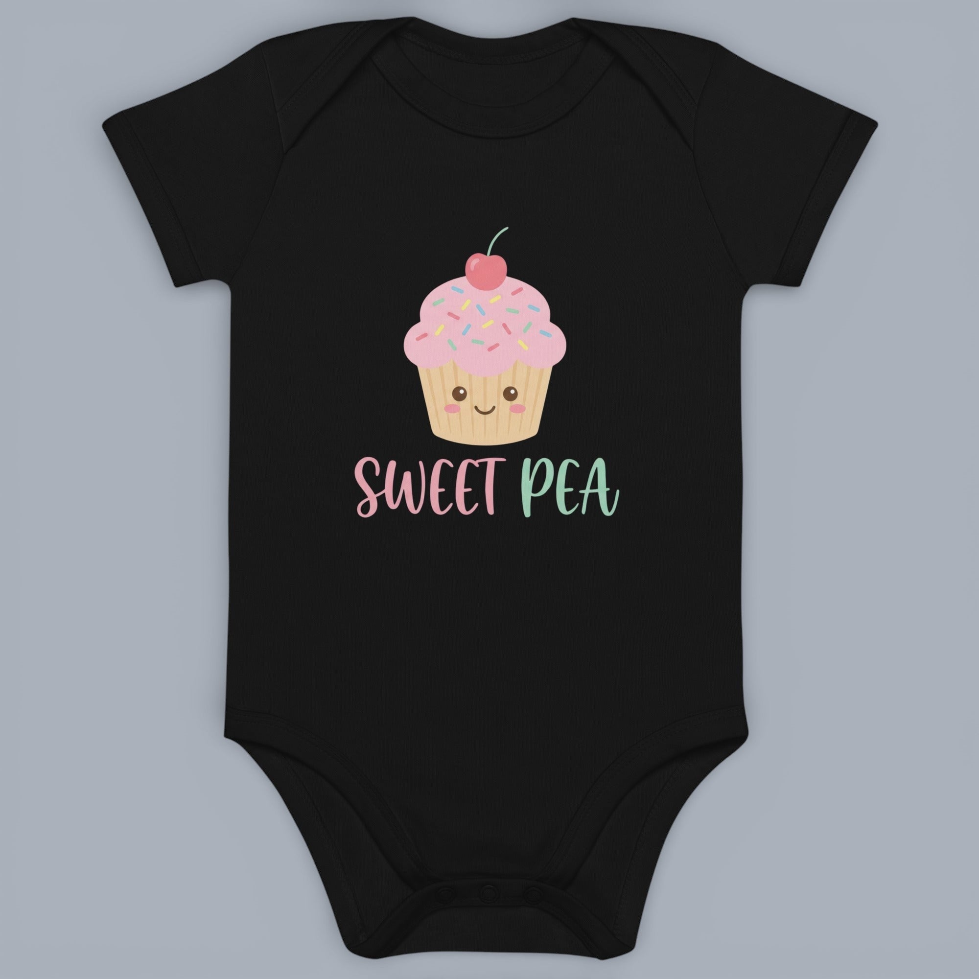 Coocosh Baby Bodysuit features a cute cupcake graphic with "Sweet Pea" text, made from soft, breathable cotton in classic black. Perfect for everyday wear and adorable photos. A comfortable and stylish choice for your little one.