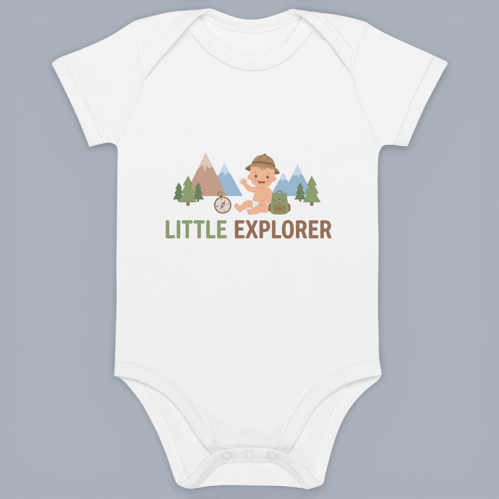 Coocosh Baby Onesie featuring a little explorer graphic design. The design includes mountains, trees, a compass, and a baby with a hat and backpack. Perfect for your little one's adventures. The onesie is white and made of soft, breathable fabric. A great