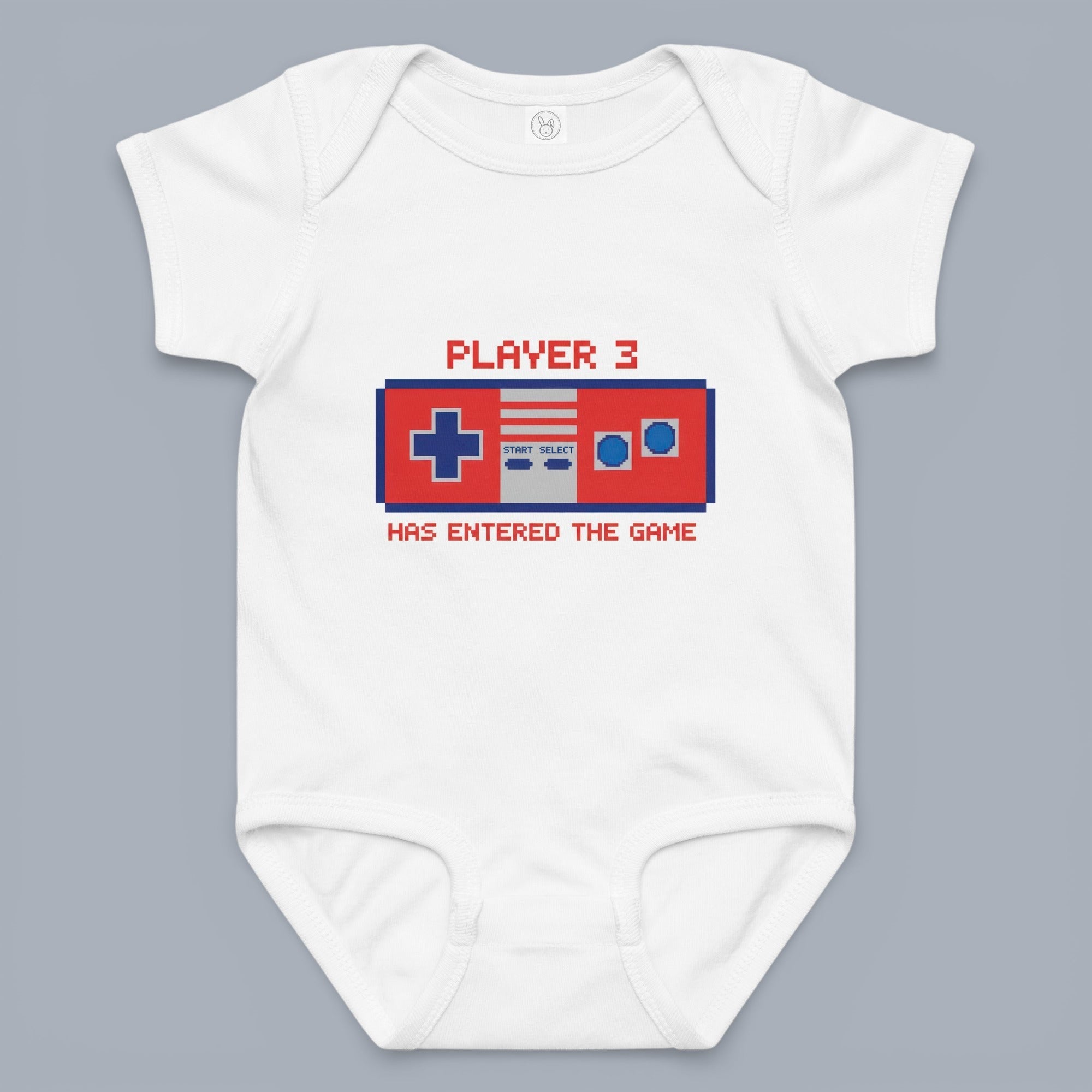 Coocosh baby bodysuit featuring a retro video game controller graphic. The design reads "Player 3 has entered the game." Made from soft, breathable white cotton. Perfect for gamers!.