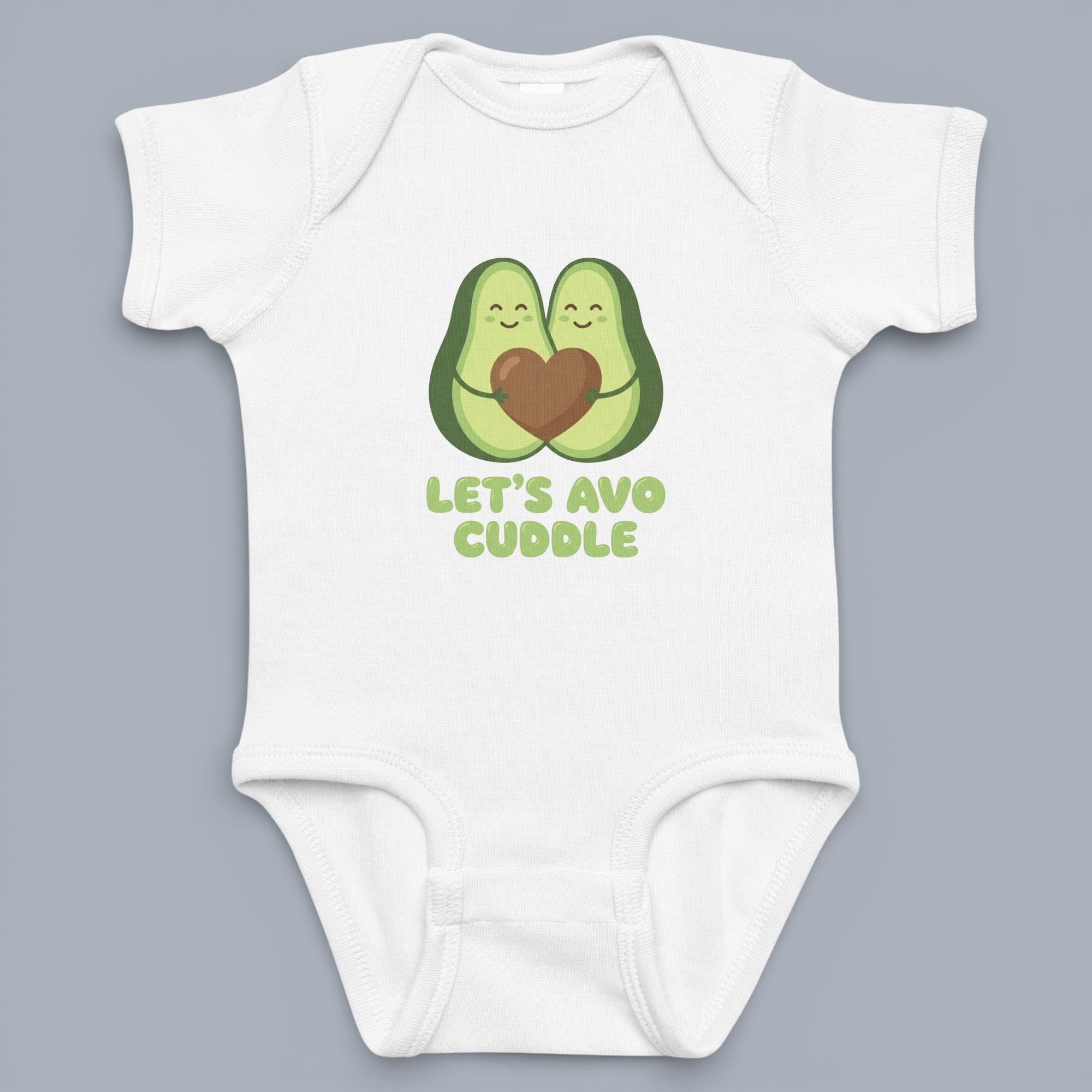 Coocosh Baby Onesie featuring two cartoon avocados hugging a heart graphic with text "Let's Avo Cuddle" in green on a white cotton blend fabric. Cute for babies. Period.