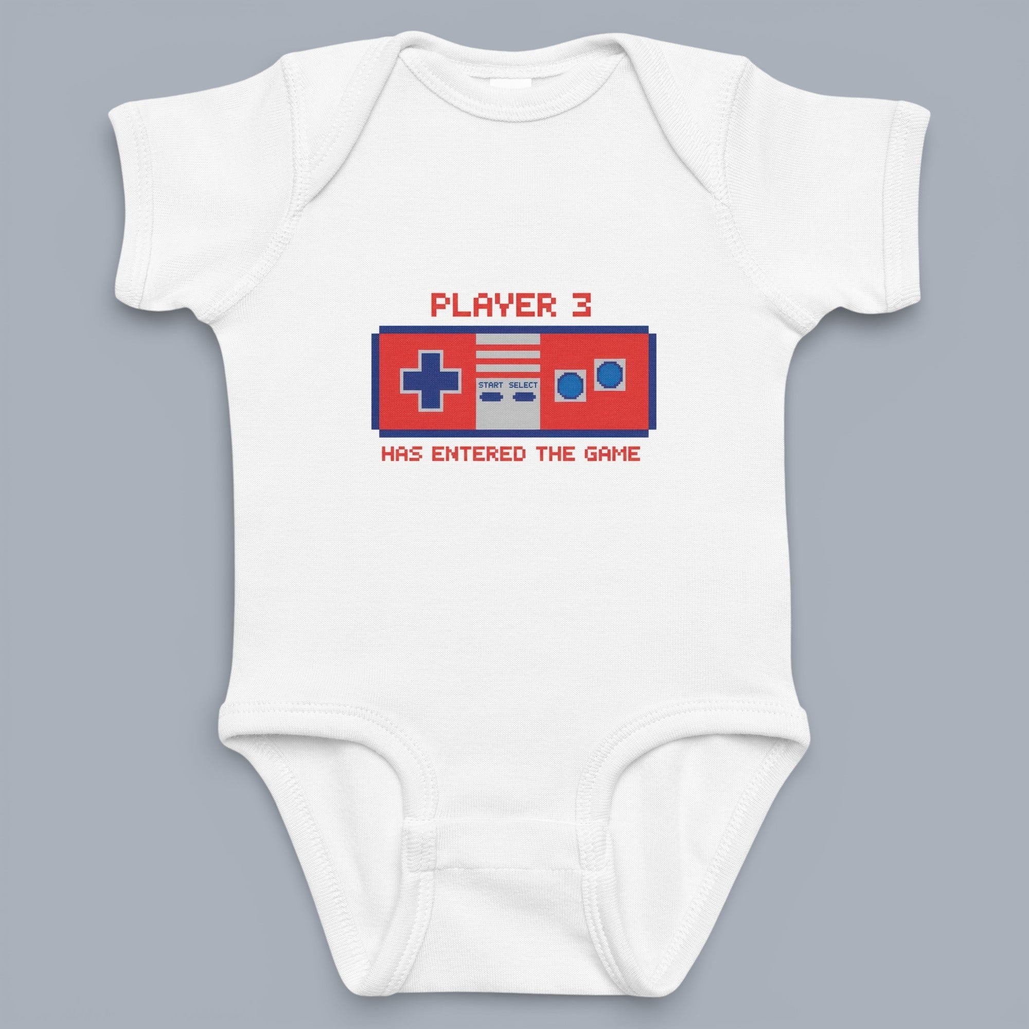 Coocosh Baby Onesie featuring a pixelated retro video game controller graphic with "Player 3 Has Entered The Game" text, made of soft white cotton for ultimate comfort.