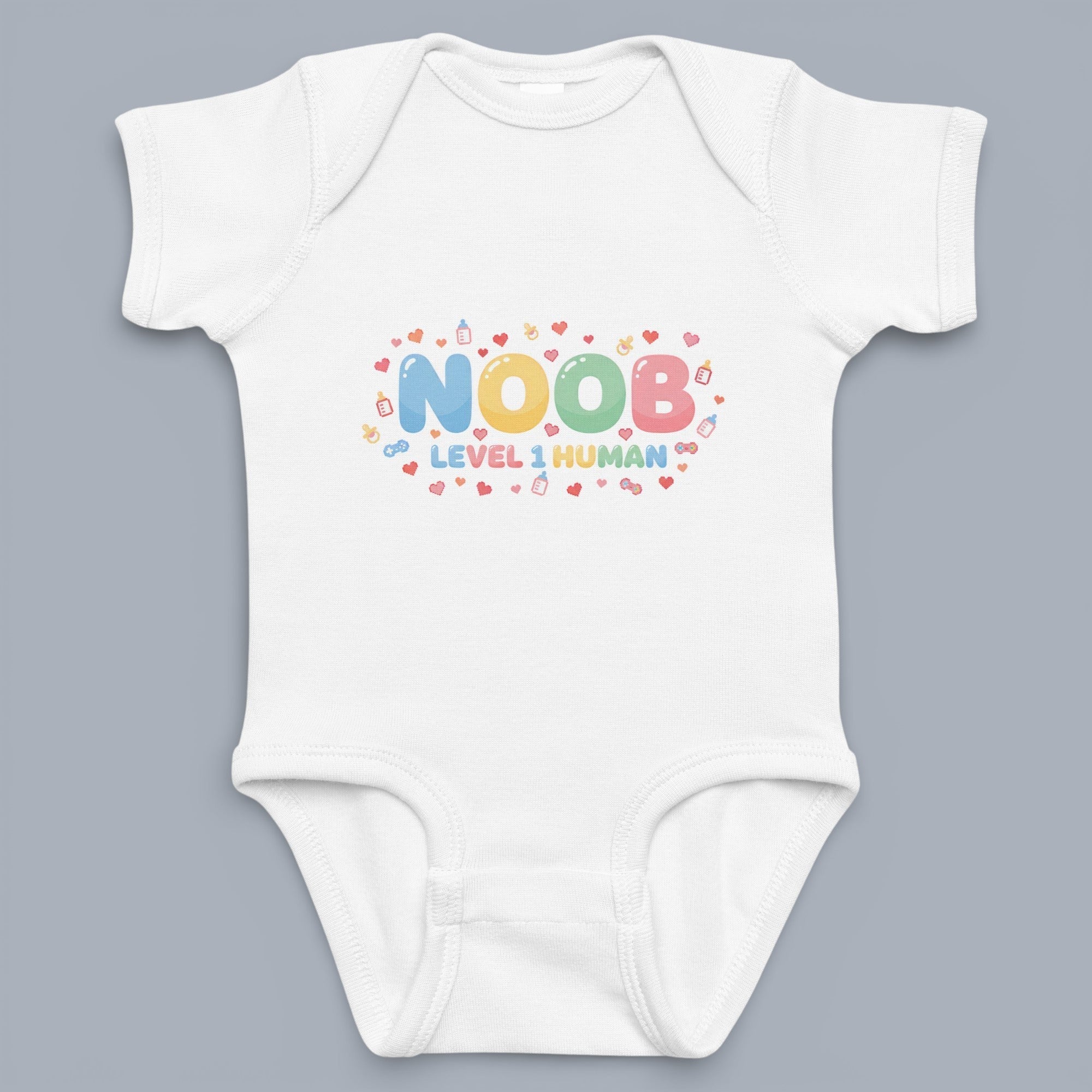 Coocosh baby onesie with the text 'Noob Level 1 Human' in bright, playful colors, surrounded by tiny baby-themed graphics on a soft white cotton fabric. Perfect for a newborn.