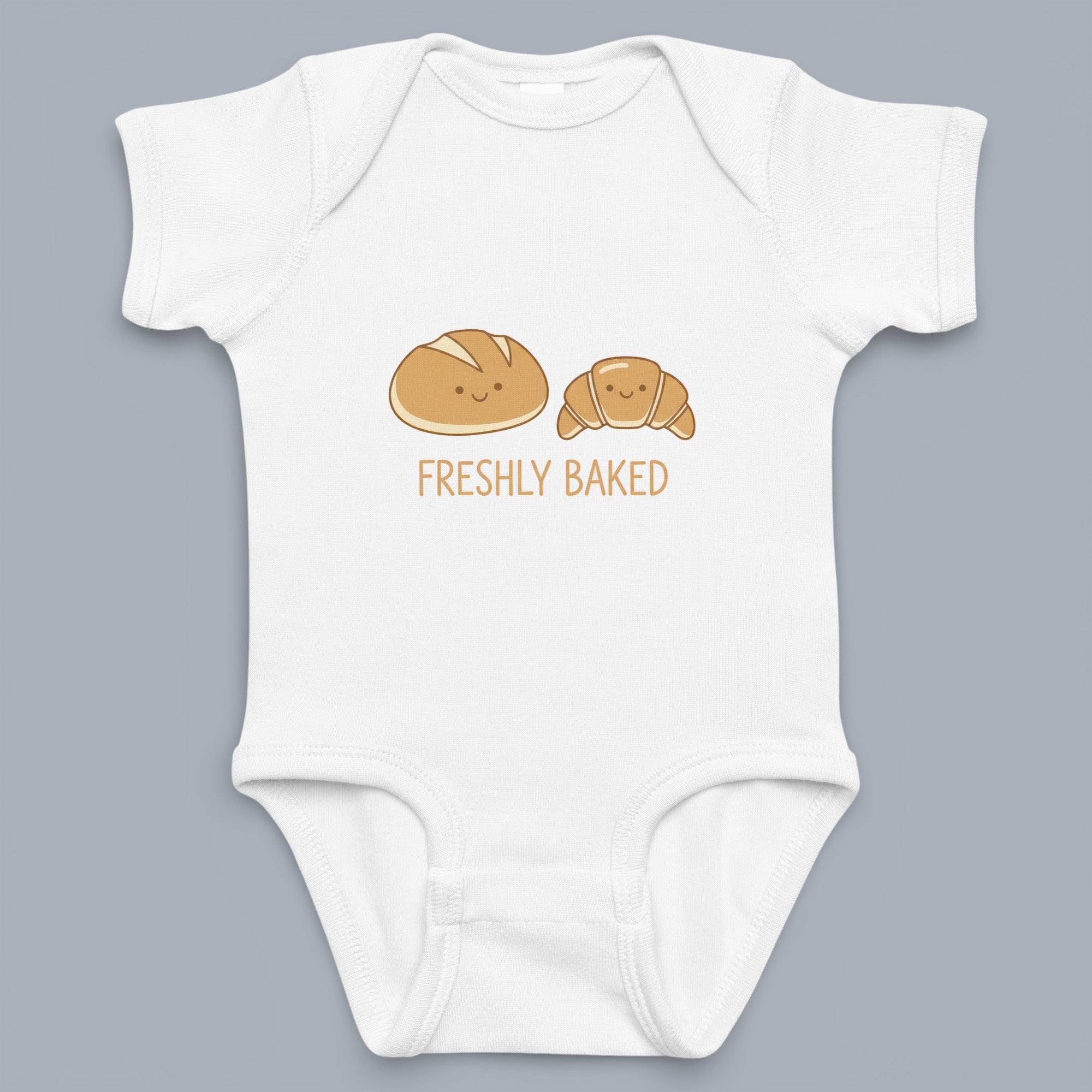 Coocosh baby onesie featuring a cute "Freshly Baked" bread and croissant design. Made of soft, breathable fabric for baby's comfort in white. Perfect for baker families. Period.