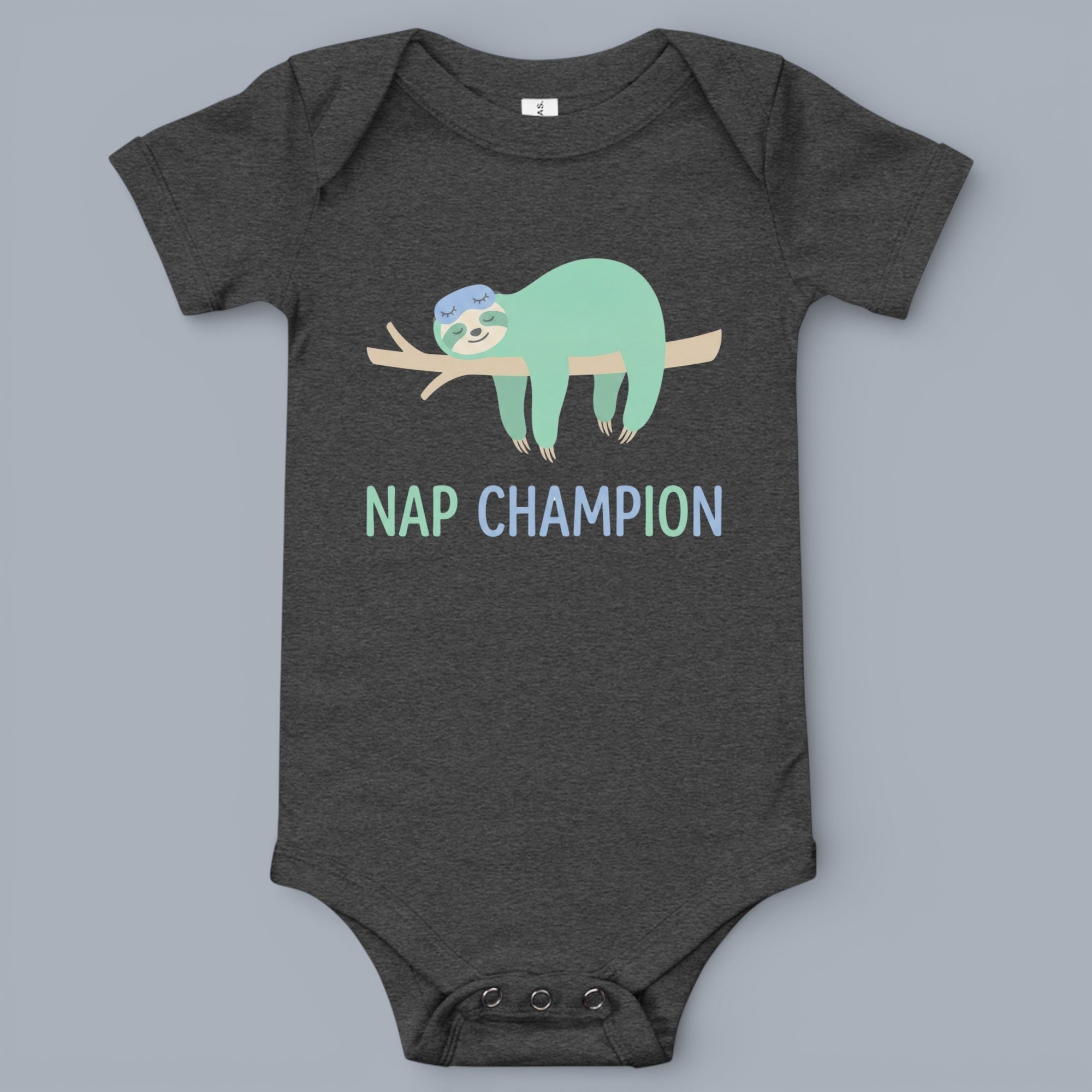 Coocosh baby bodysuit featuring a cute sloth wearing an eye mask taking a nap on a branch graphic, with 'Nap Champion' text. Soft, comfortable fabric in heathered gray for infants.
