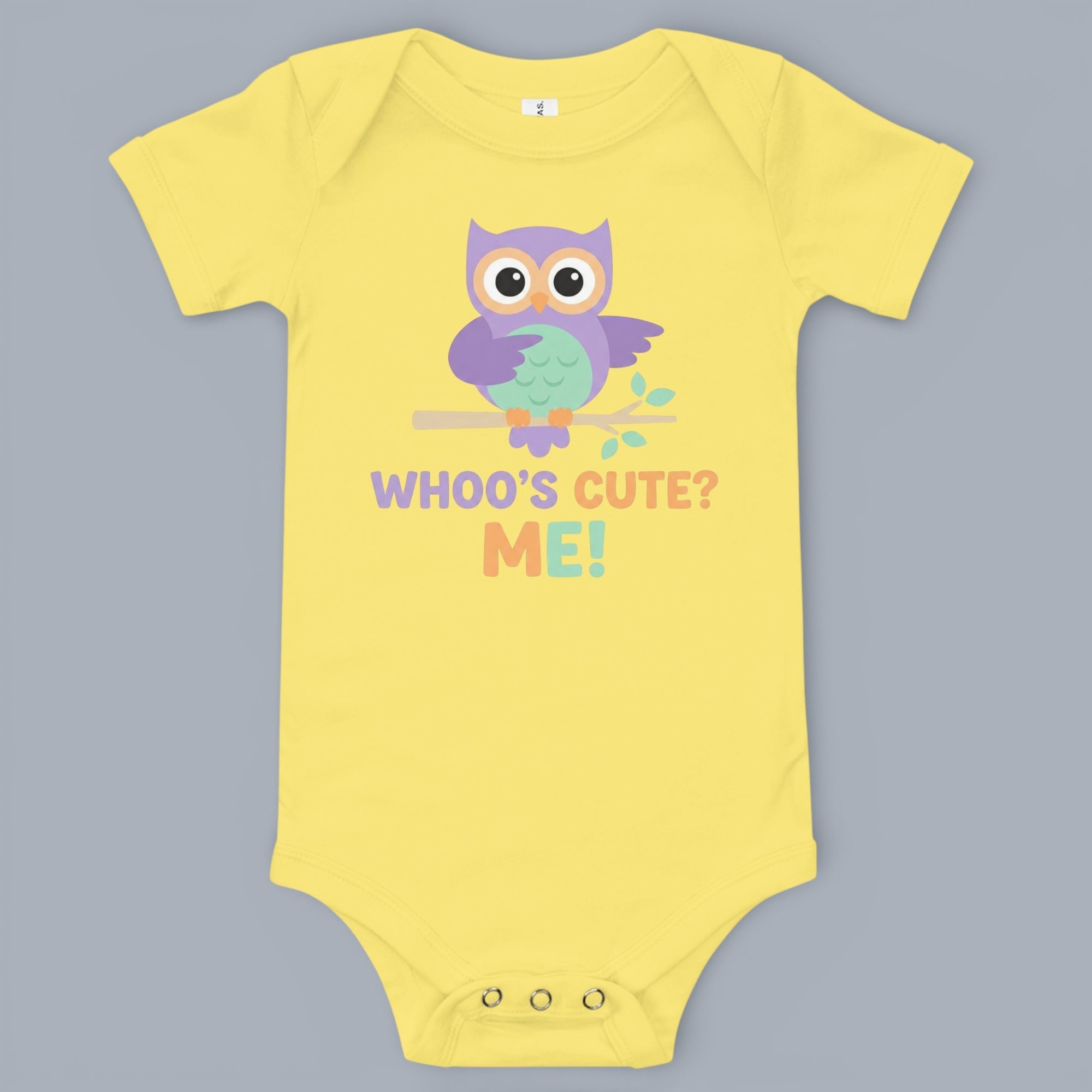 Coocosh baby onesie with a cute owl design and the playful text 'WHOO'S CUTE? ME!'. Short sleeves and snap closures ensure easy dressing. The soft yellow fabric provides comfortable wear for infants. A charming and practical choice for your little one's w