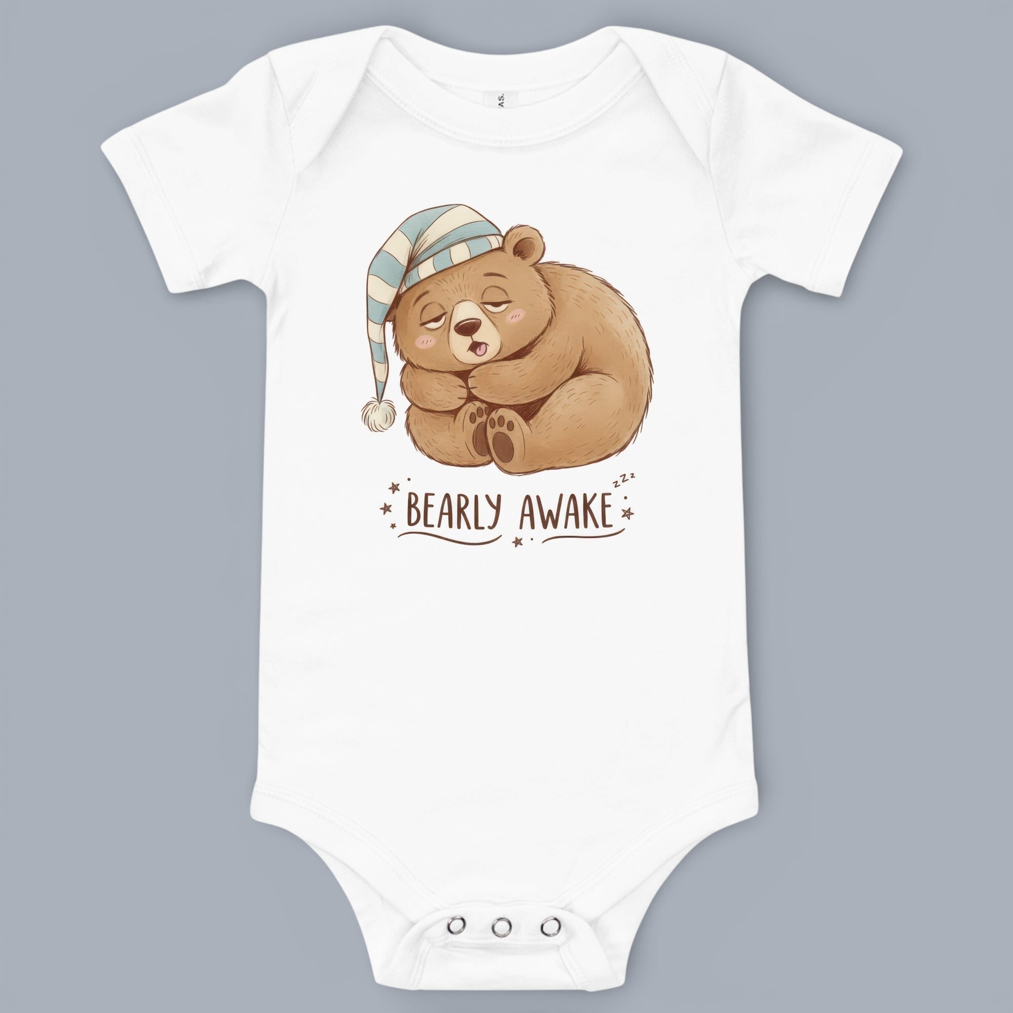 Coocosh Baby Onesie featuring a whimsical illustration of a sleeping bear wearing a blue and white striped nightcap, printed on soft white fabric, perfect for baby's sleep time..
