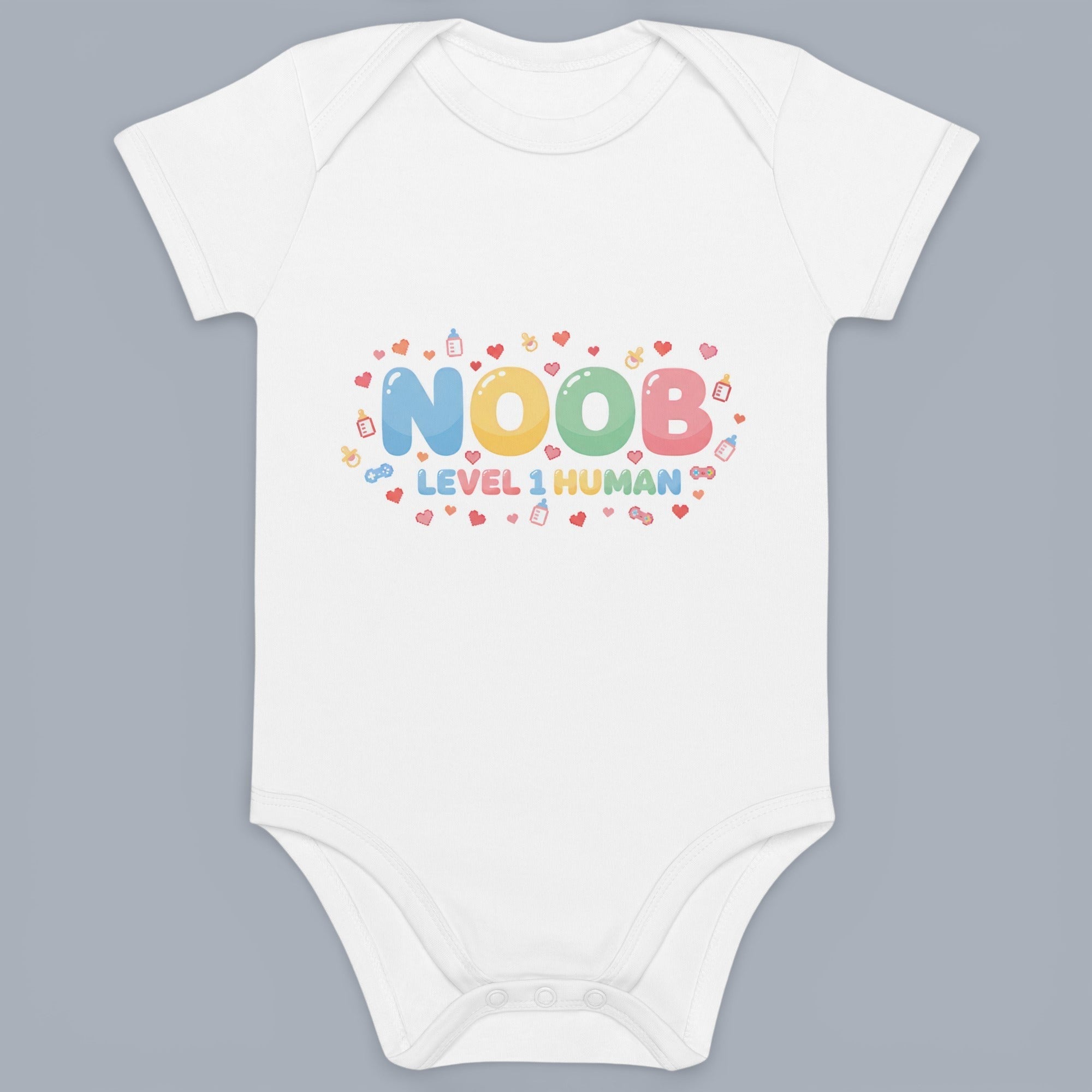 Coocosh Baby Onesie features the text "NOOB Level 1 Human", a humorous design, and short sleeves. Made from soft, white fabric, perfect for a baby shower gift. A cute outfit for newborns.
