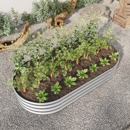 Coocosh Raised Garden Bed, made of durable galvanized steel, providing a contained space for growing vegetables and herbs, silver colored with rounded edges, seen outdoors in a gravel garden, landscape perspective. A good addition for gardeners and small 