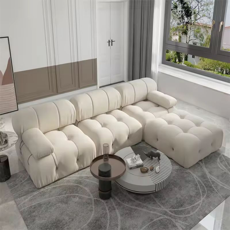 Coocosh L-shaped Sofa with plush tufted design in cream color, ensuring comfort and style for any living space, dimensions 90x70 inches, viewed from a main perspective within a modern interior.