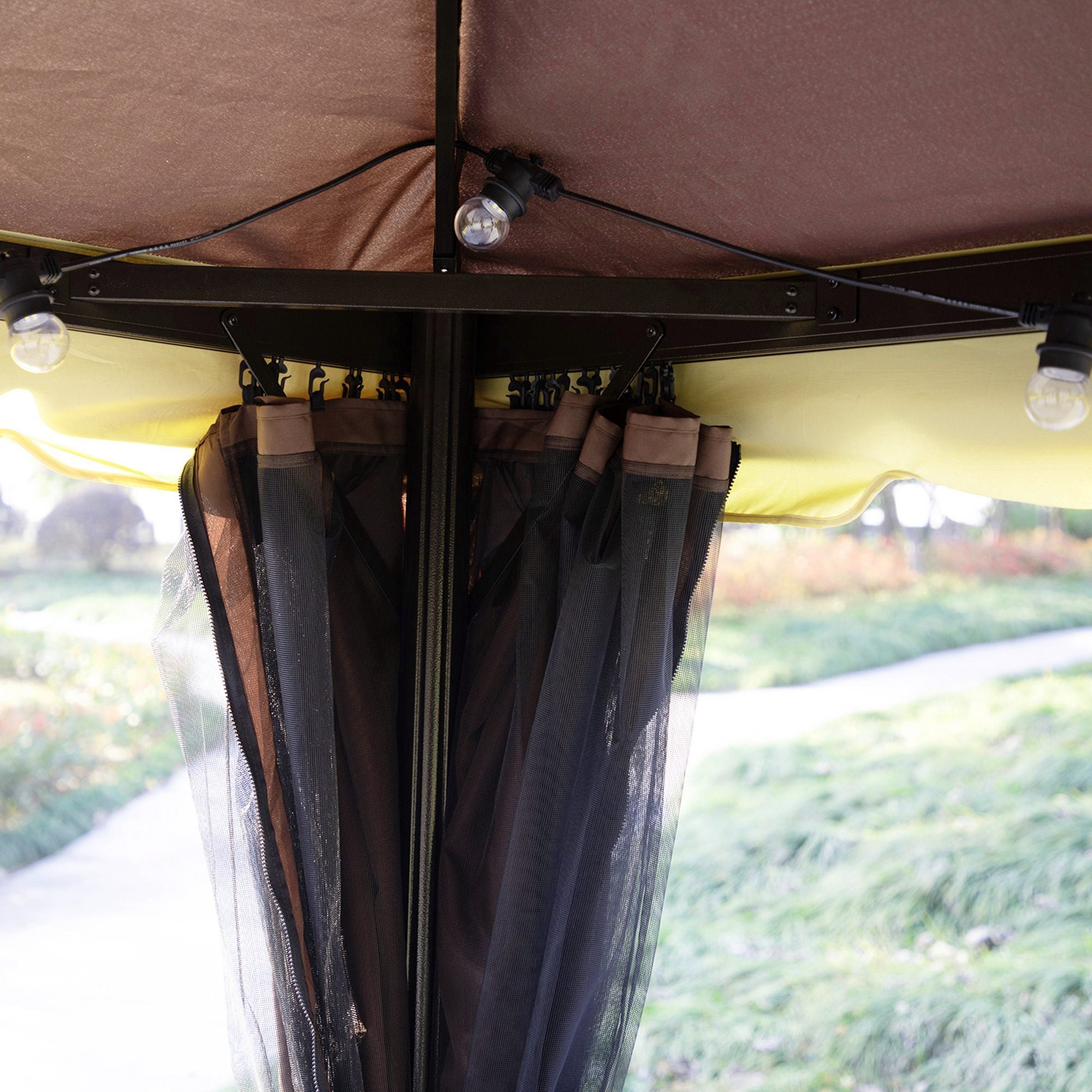 Coocosh Canopy with lightweight PE netting and elegant dual-tone curtains in brown and black, featuring integrated lights for ambiance. Close-up view showcasing the curtain details and structural design.