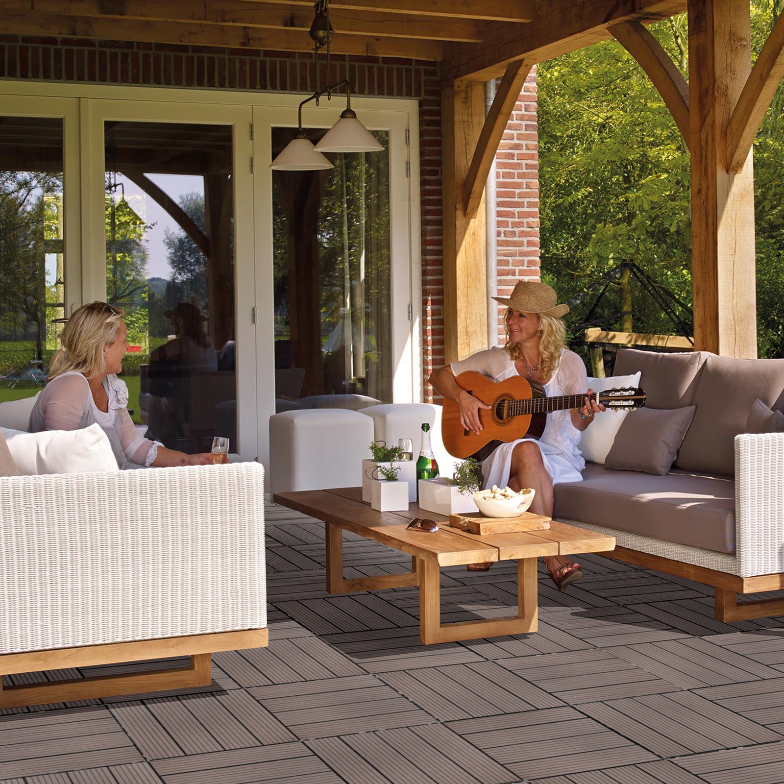 Coocosh Outdoor Lounge Set featuring plush grey cushions, light wood frame, and a stylish coffee table with white planters, providing a cozy atmosphere for outdoor gatherings on a sunny day.