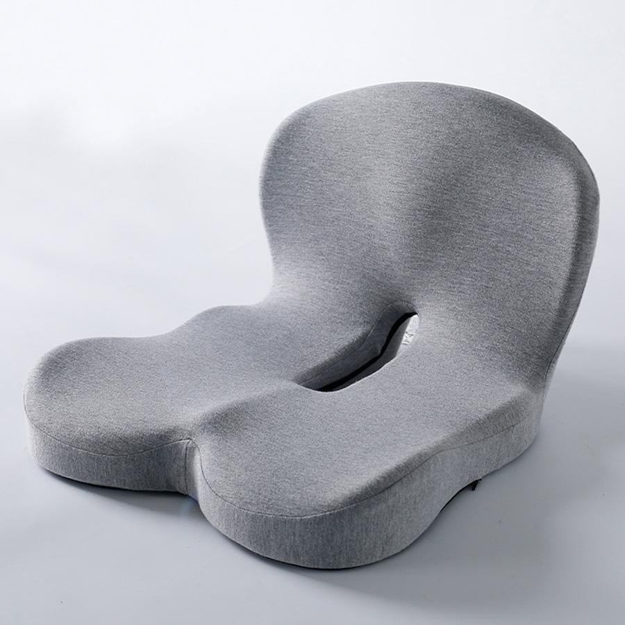 Coocosh ergonomic seat cushion in grey, designed with a unique U-shaped cutout for optimal spinal alignment and pressure relief, shown from a slightly elevated angle to highlight its supportive contours.