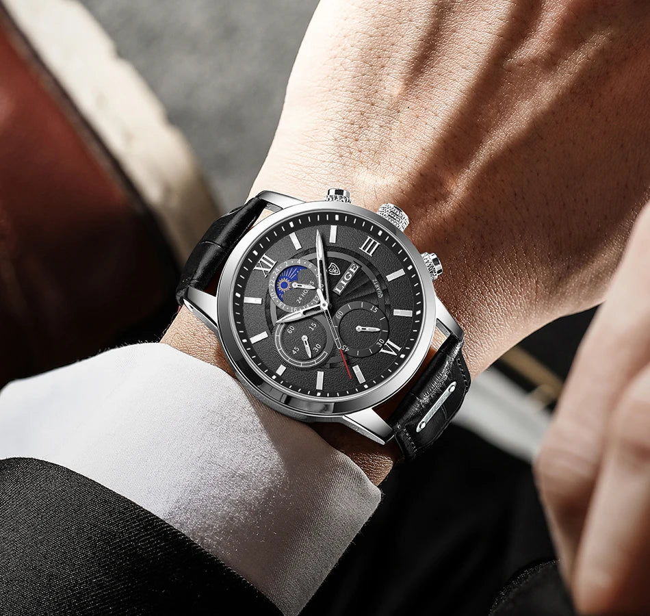 Coocosh's luxurious black dial quartz watch, framed in a sleek silver case and complemented by a brown leather strap. This elegant timepiece, designed for the modern gentleman, seamlessly elevates any formal attire while ensuring precision and style for every occasion.