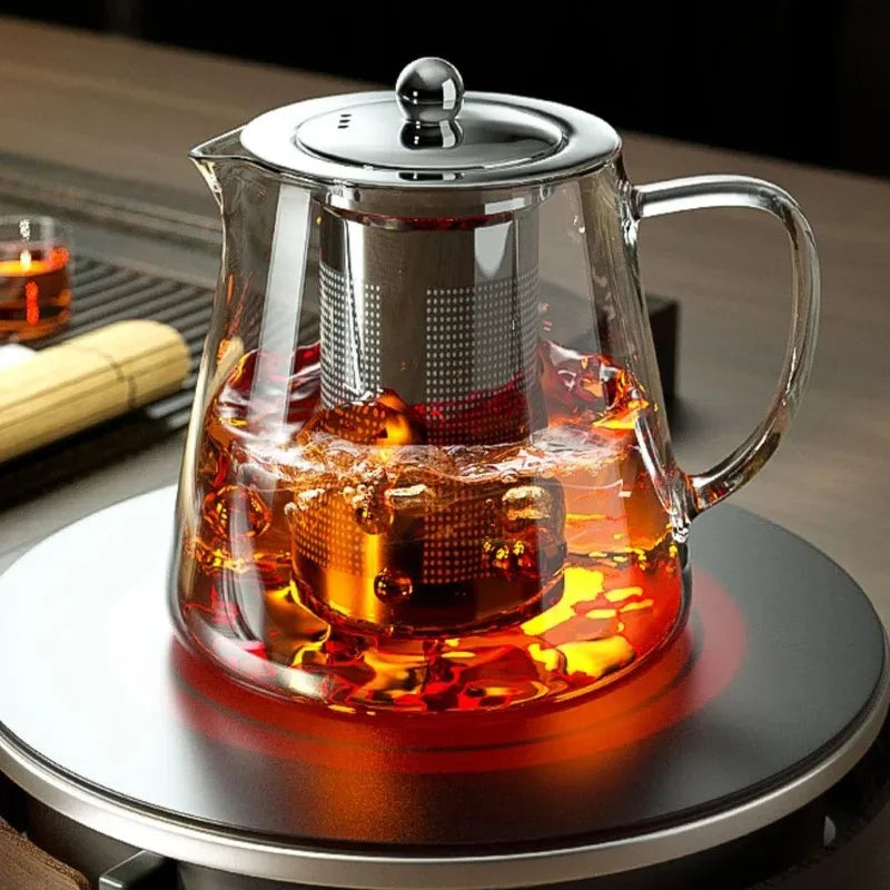 Coocosh glass teapot, elegantly designed with heat-resistant borosilicate for precision brewing. Infuser included for rich flavors, ideal for modern kitchens or serene tea moments. Perfectly complements any countertop, ensuring warmth and style in every sip.