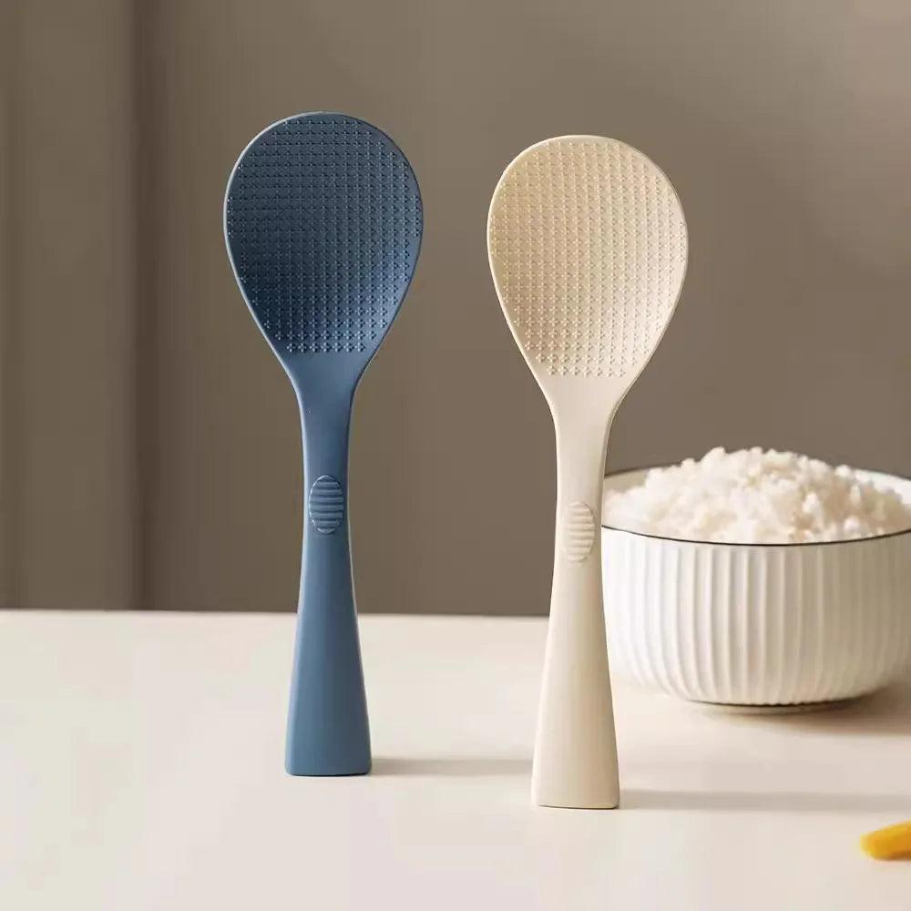 Coocosh blue and white textured silicone rice spoons, designed for effortless serving with an ergonomic grip. Heat-resistant and non-stick, they elevate meal preparation, seamlessly blending functionality with style on any kitchen surface.