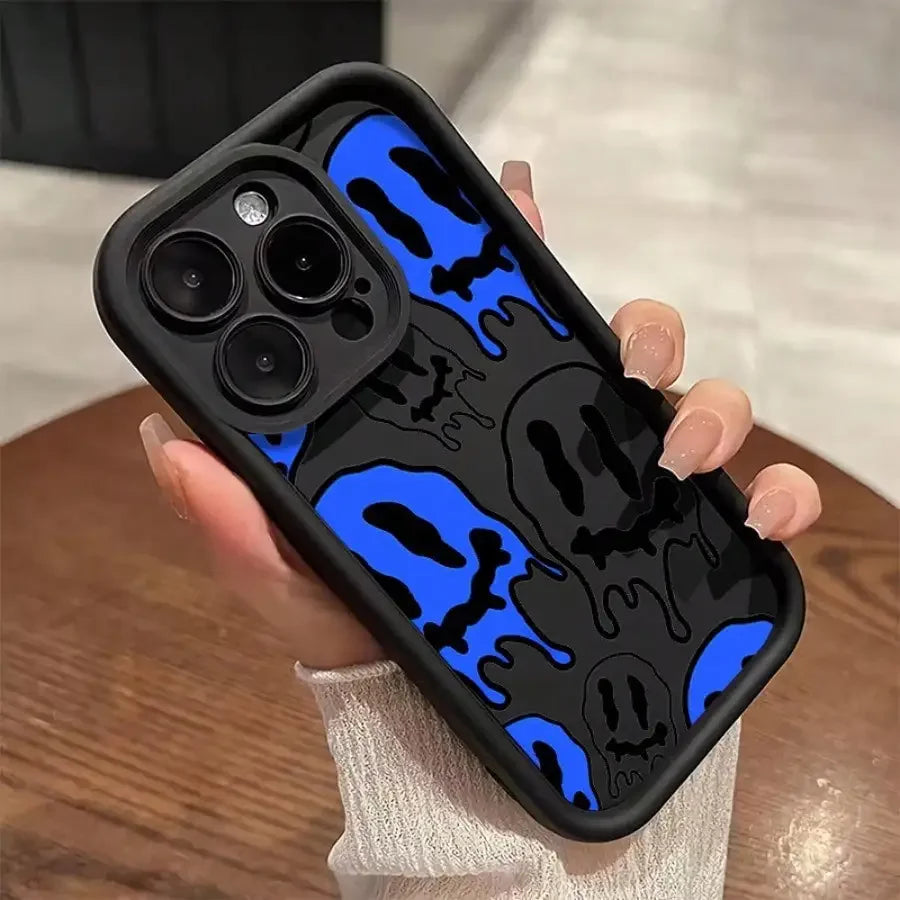 Coocosh artful iPhone case, draped in a striking black background with ethereal blue shapes, elevating protection and style. Perfectly designed to enhance grip and flair, this case inspires creativity while complementing any elegant wooden setting.