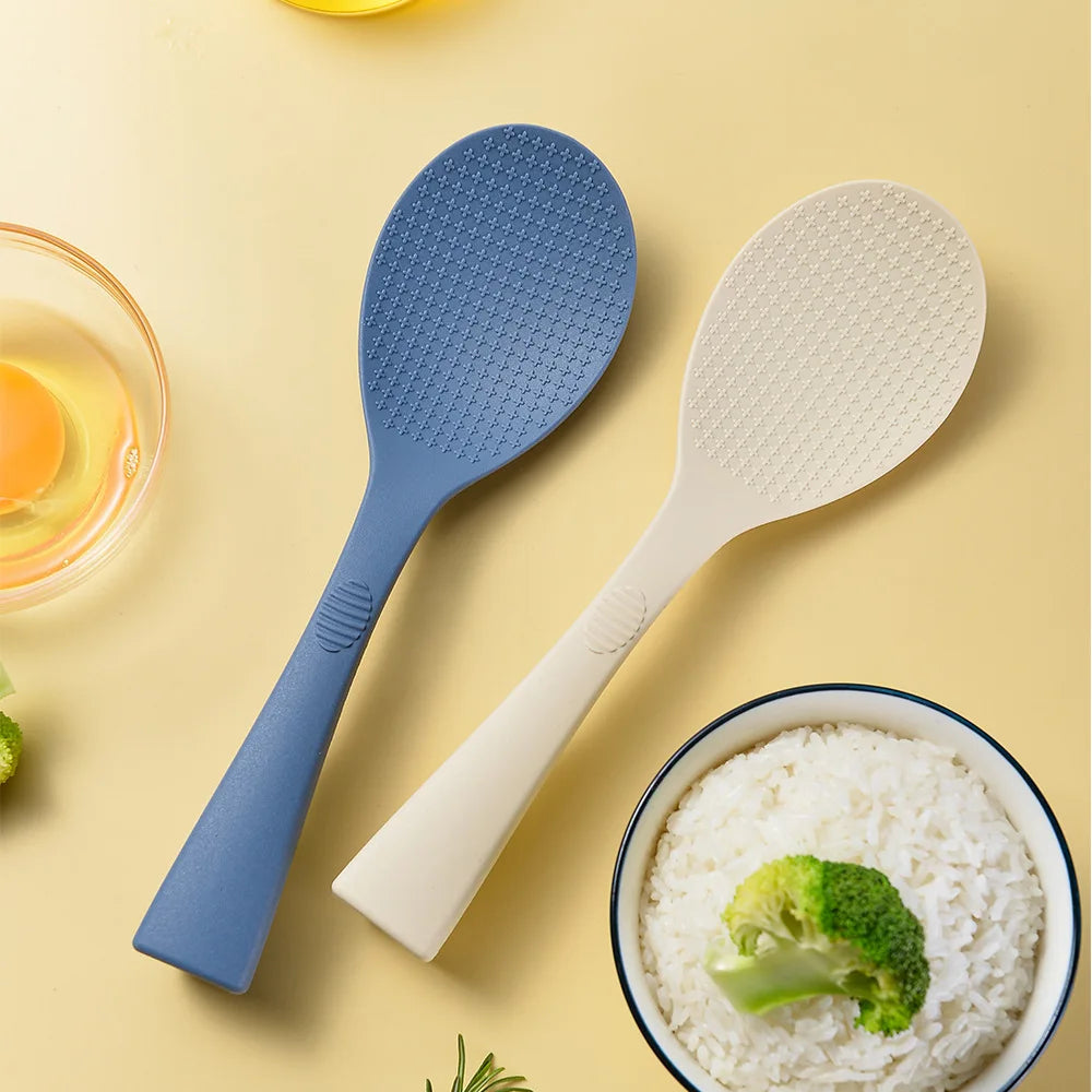Coocosh's vibrant blue and white silicone rice spoons, elegantly displayed against a sunny yellow backdrop, feature a heat-resistant, non-stick design for effortless serving and cooking, enhancing every meal with ergonomic comfort and style.