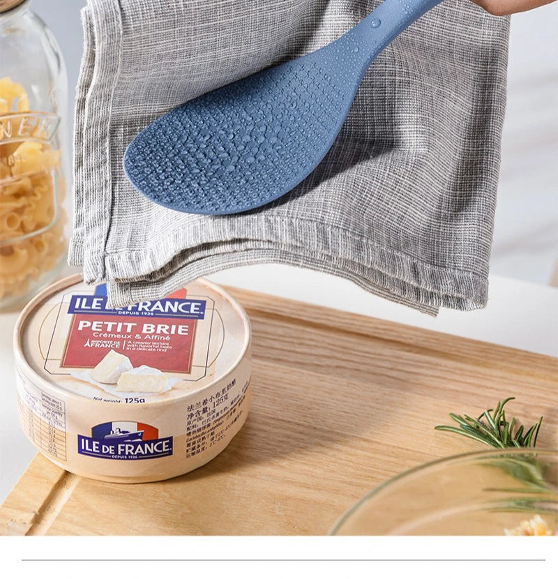 Coocosh heat-resistant silicone rice spoon elegantly positioned beside rich pâté, blending style and functionality on a rustic wooden surface, ensuring effortless serving and preparation in your culinary adventures.