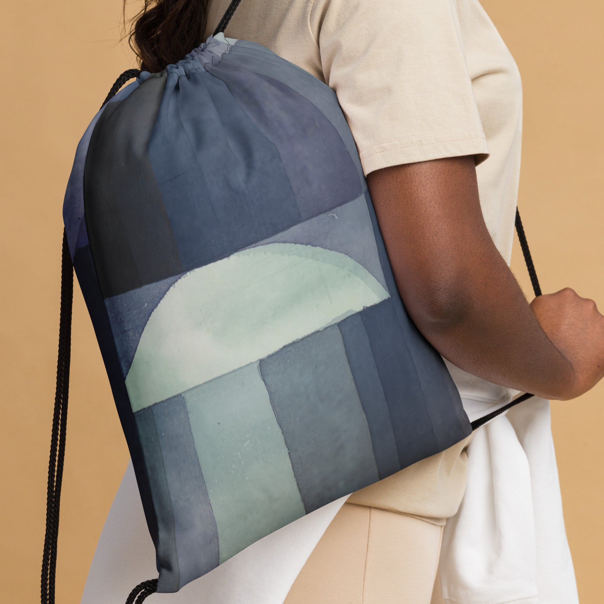 Coocosh drawstring bag showcasing an abstract geometric design in soothing blue and green tones, perfect for an active lifestyle. Crafted from durable, lightweight polyester with comfortable cotton handles, it effortlessly combines style and functionality for gym or daily use.