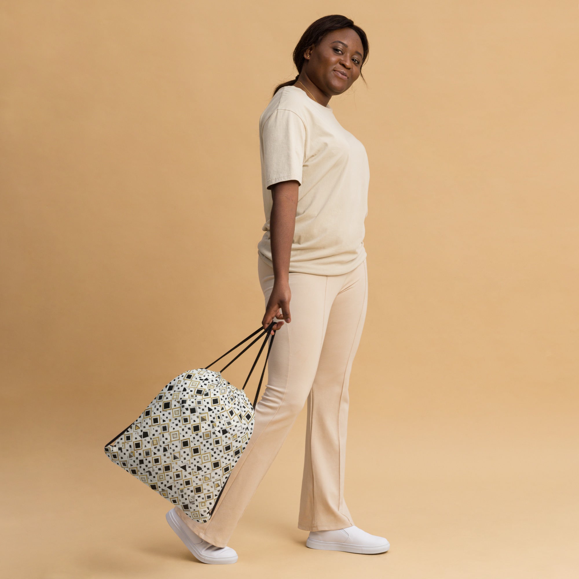 Coocosh Quantum Prism geometric pattern drawstring bag in stylish hands, embodying durability and versatility for gym essentials or travel. Elevate everyday adventures with a lightweight design that ensures secure closure and effortless chic.