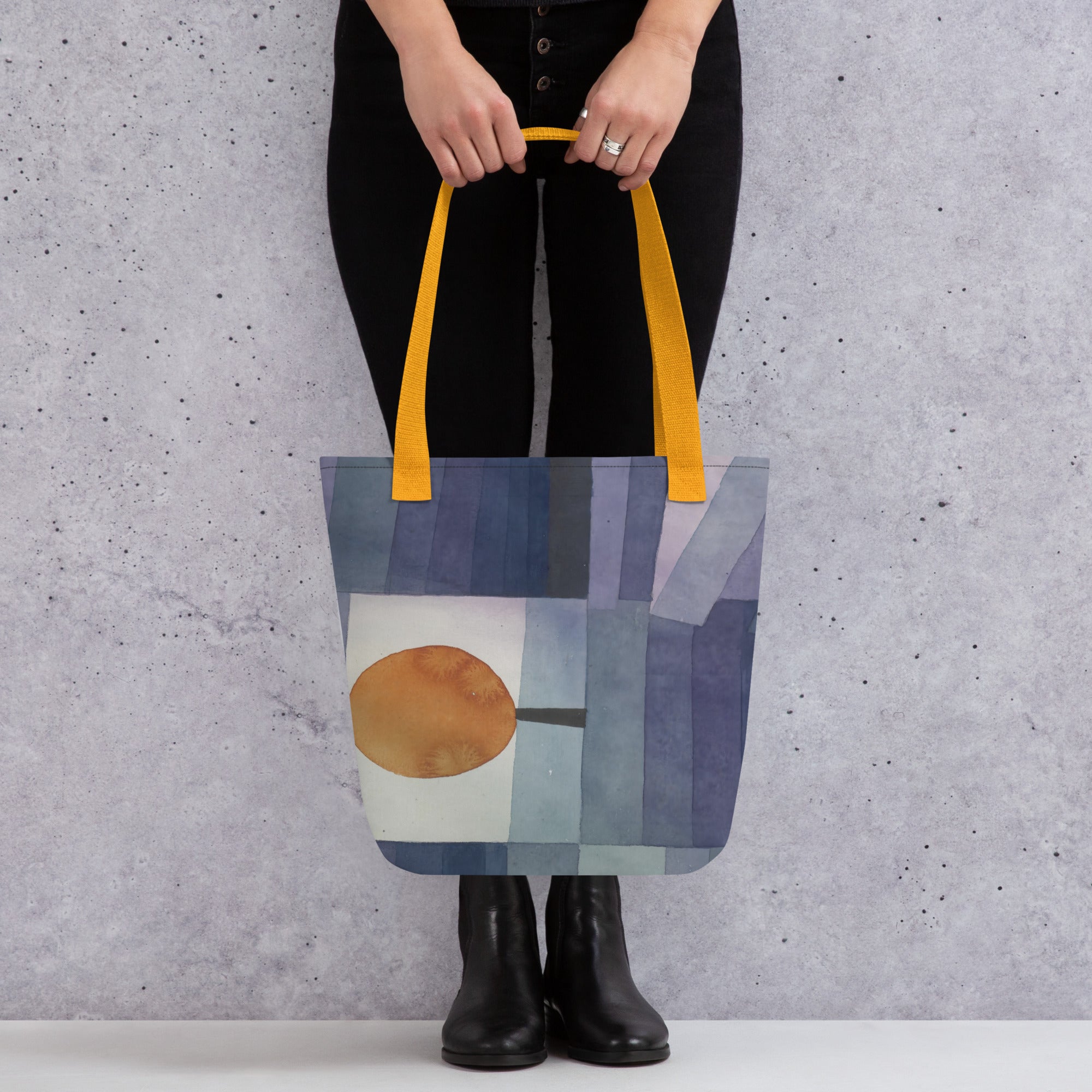 Coocosh's 'Der Bote des Herbstes' tote bag features an eye-catching abstract design with vibrant blues and a striking orange circle. Its durable 100% polyester fabric and cotton handles make it a spacious, eco-friendly accessory for the modern fall wardrobe.
