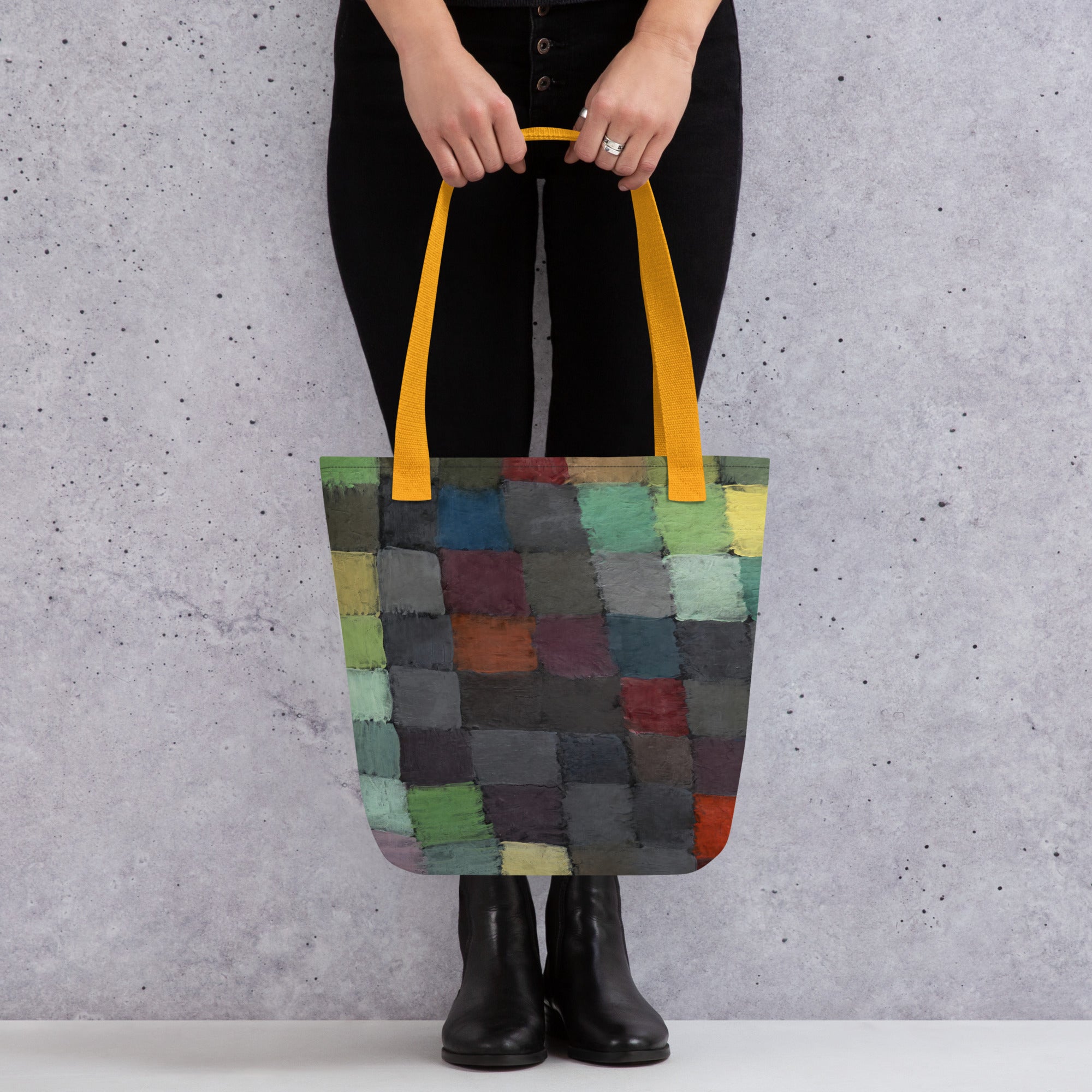 Coocosh vibrant patchwork tote bag, artfully designed with a spectrum of colors and durable polyester, perfect for beach outings or market trips. Lightweight with practical cotton handles, it combines style and functionality for versatile use against a chic textured backdrop.