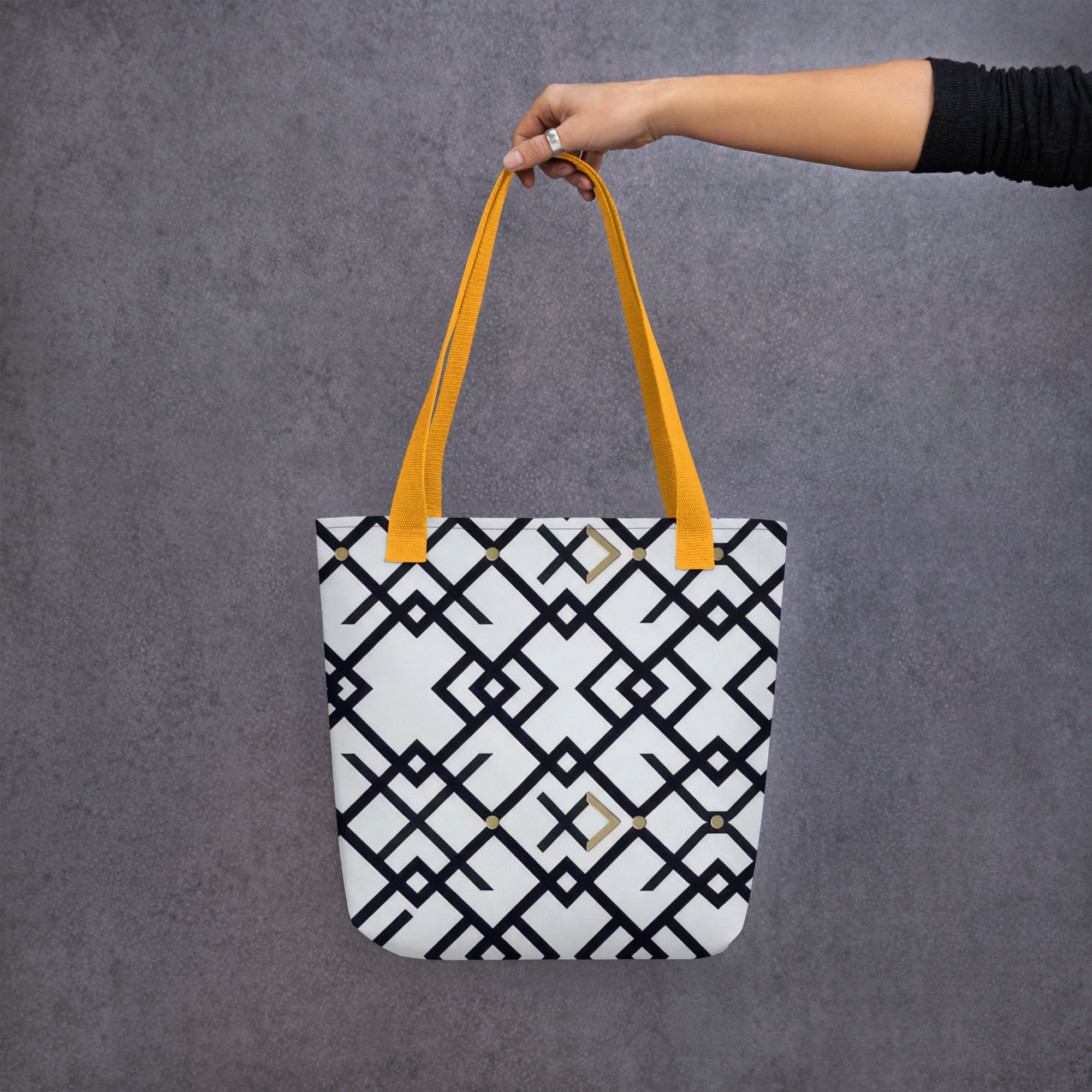 Coocosh Midnight Meridian tote bag, featuring a striking geometric black and white design with vibrant yellow straps, perfectly balancing style and durability while effortlessly enhancing your everyday adventures.