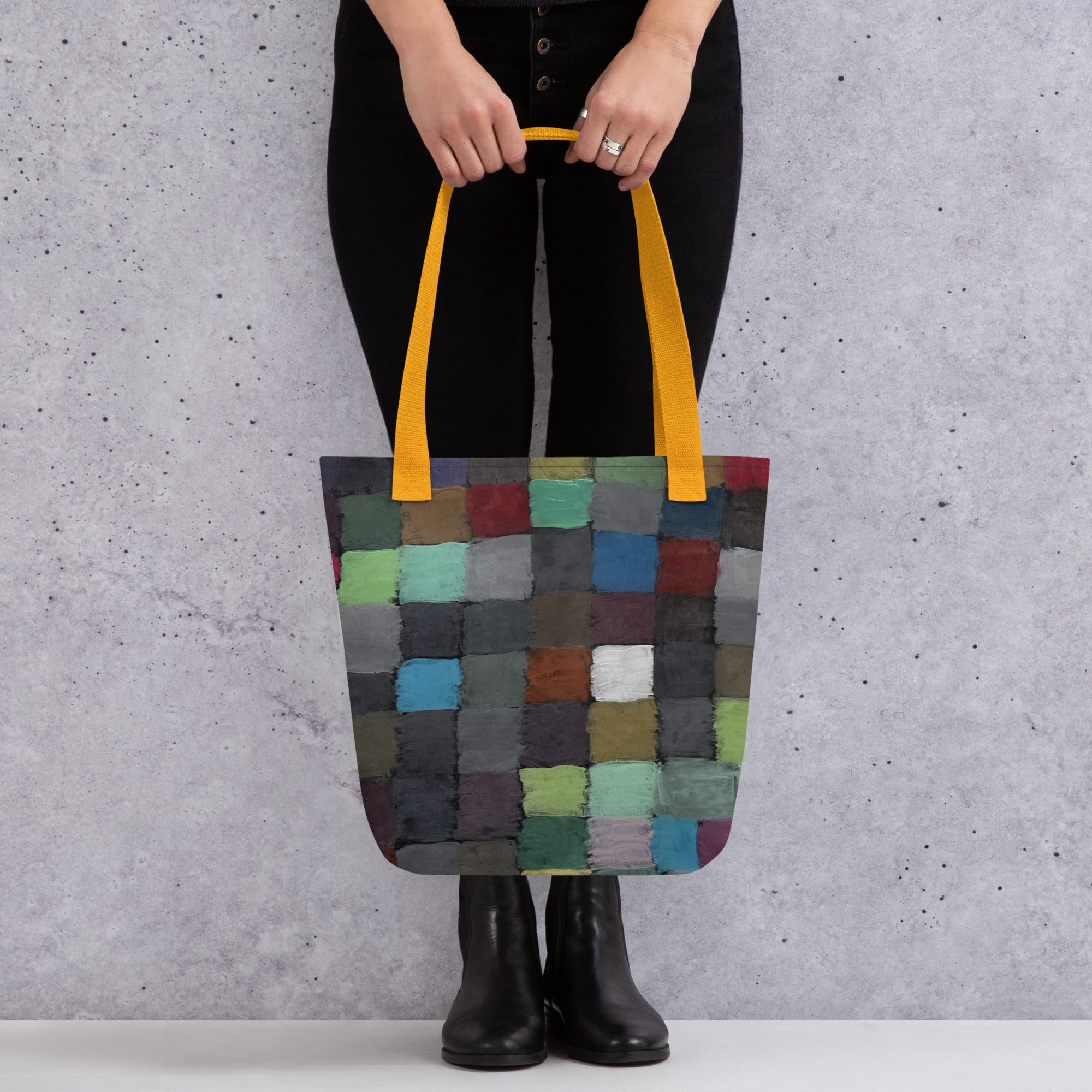 Coocosh vibrant patchwork tote bag, featuring colorful square patterns and durable yellow handles, perfect for spontaneous adventures while offering spacious functionality and stylish flair for modern living.