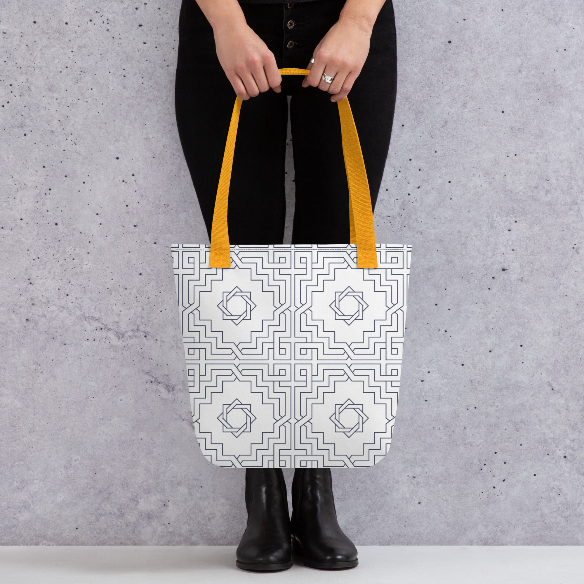 Coocosh Zenith Lattice tote bag, featuring a vibrant white floral pattern with striking orange handles, perfect for stylish errands or beach outings, seamlessly elevating any outfit against a chic gray backdrop.