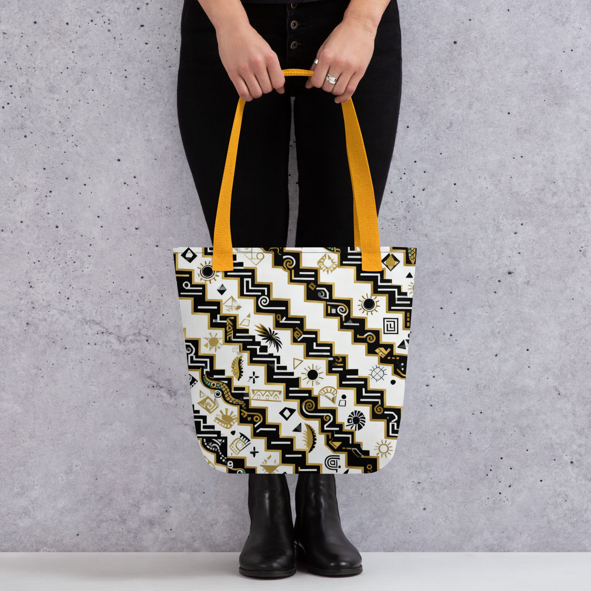 Coocosh Serpents Path tote bag, featuring striking black and white zigzag patterns adorned with vibrant yellow straps, effortlessly combines style and sustainability for carrying essentials in a chic, urban setting.