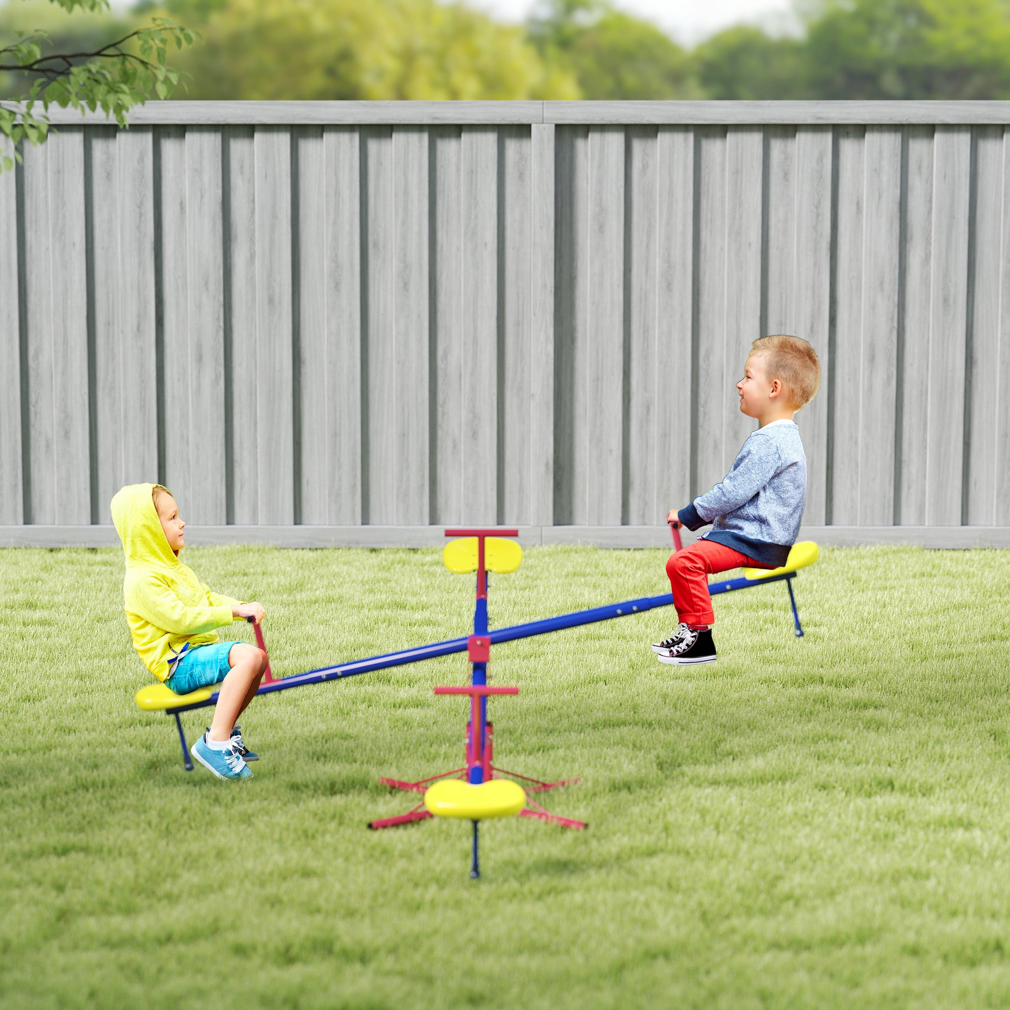 Coocosh Outdoor Seesaw with Double-spiked Supports, Durable Plastic and Metal Construction, Bright Multicolor, Ideal for Kids, Dimensions 48in x 12in, Lifestyle shot on lush green grass.
