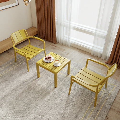 Coocosh Dining Set featuring durable PE netting chairs and a matching table in sunny yellow, perfect for indoor or outdoor use. This lifestyle shot captures a modern, inviting space with light streaming through large windows.