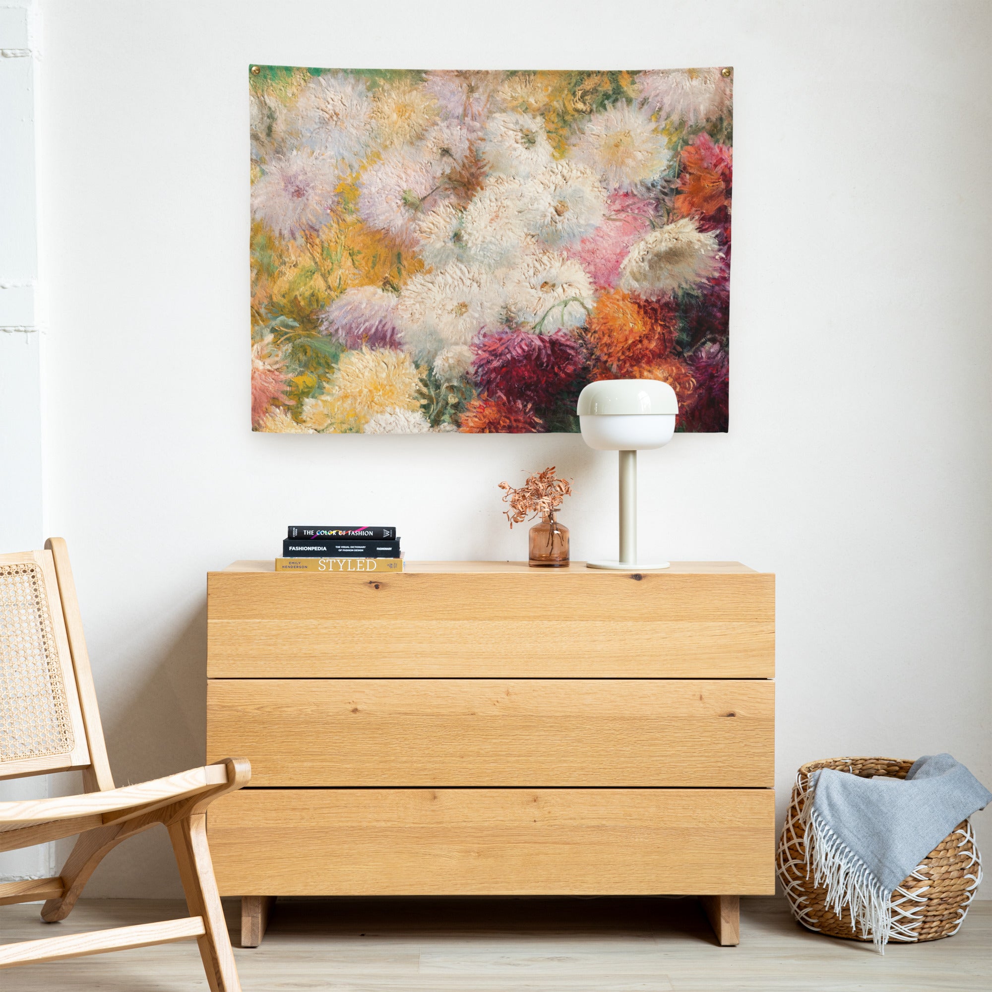 Coocosh's vibrant chrysanthemum indoor tapestry, beautifully enhancing minimalist spaces, effortlessly complements the light wood dresser while adding depth and color—creating a cozy atmosphere and elevating wall aesthetics in your home.