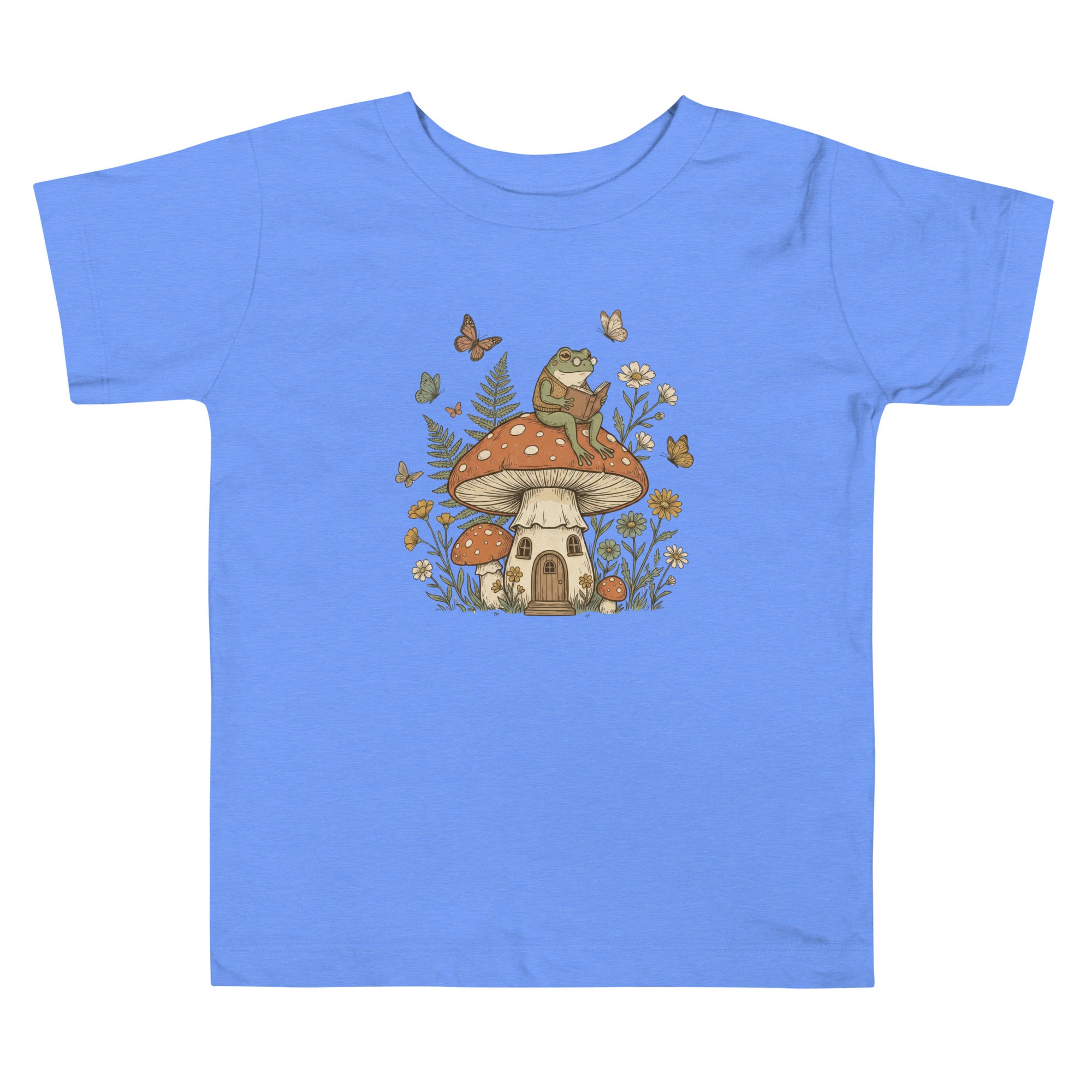 Coocosh Kids' T-Shirt featuring a delightful design of a frog reading a book on a mushroom house, surrounded by butterflies and flowers, in a vibrant blue color. Perfect for children's wear.
