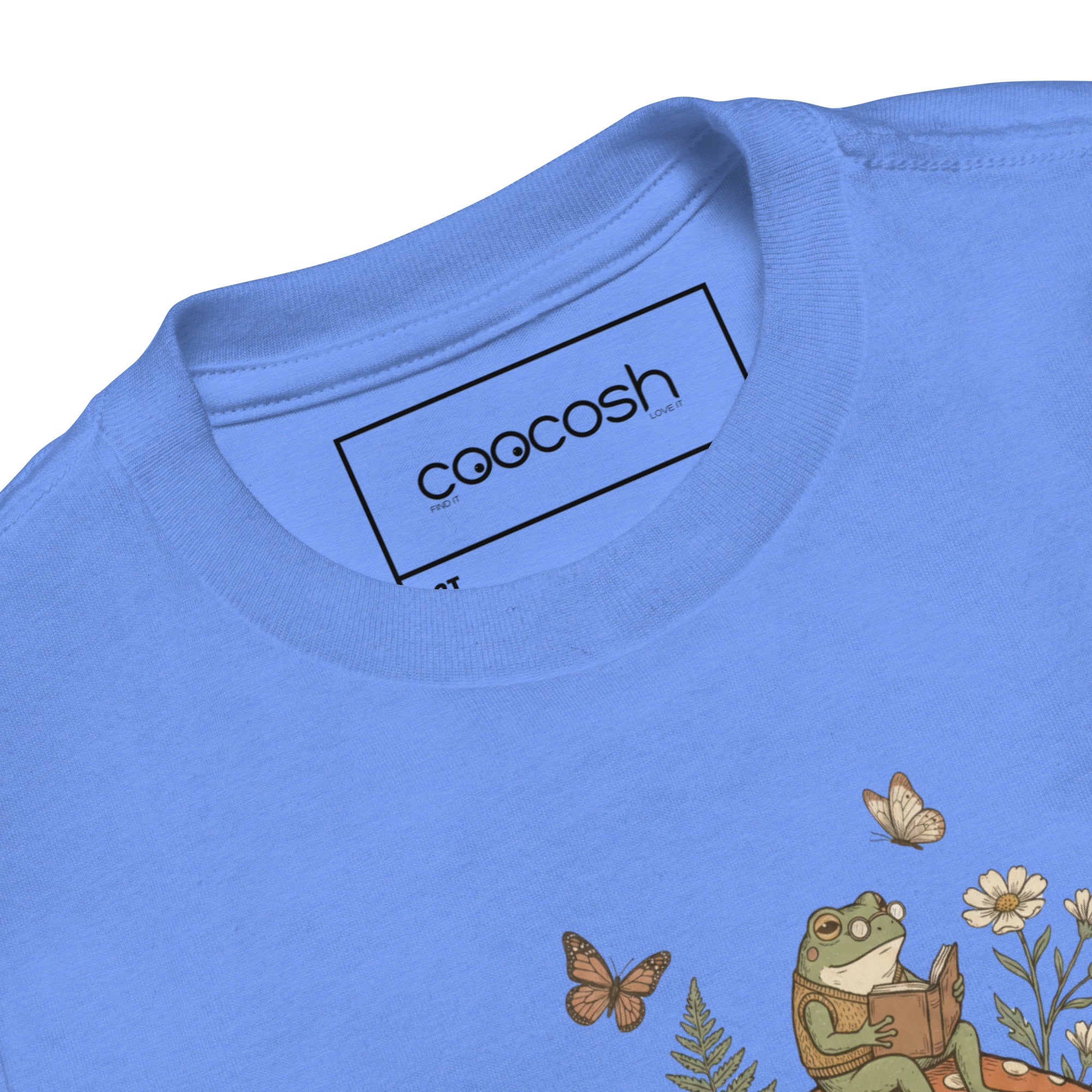 Coocosh short sleeve shirt, crafted from breathable cotton, decorated with whimsical frogs and mushrooms, suitable for toddlers' playful outings.